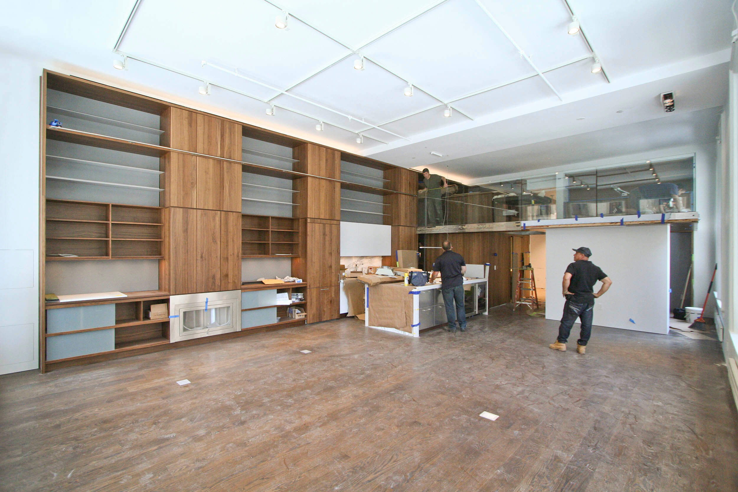 Communal space (living room, kitchen, dining area, and study/sleeping loft above) - 14-foot high ceilings allow for a study/sleeping loft accessed by a Walnut spiral stair integrated into the "Library Wall".