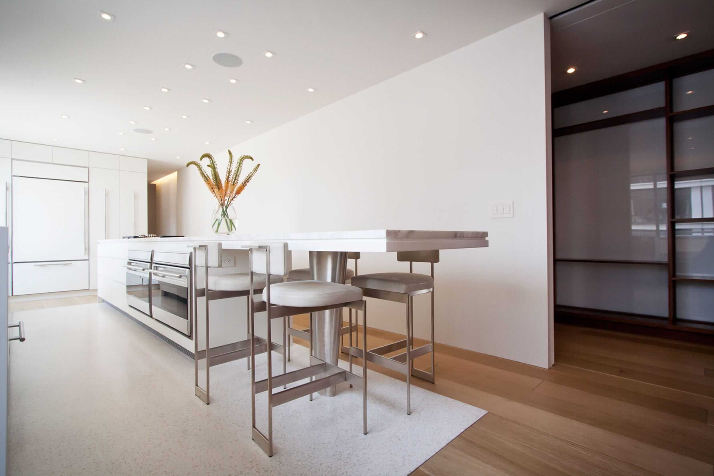 Modern Apartment Renovation | East End Ave New York City | Kitchen White Custom Cabinets Stone Countertop Stools | RES4