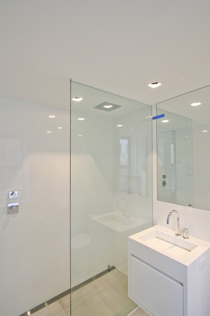   Bathroom  -  Glass partition to prevent splashing for the shower and floating vanity to complement the modern aesthetic.  