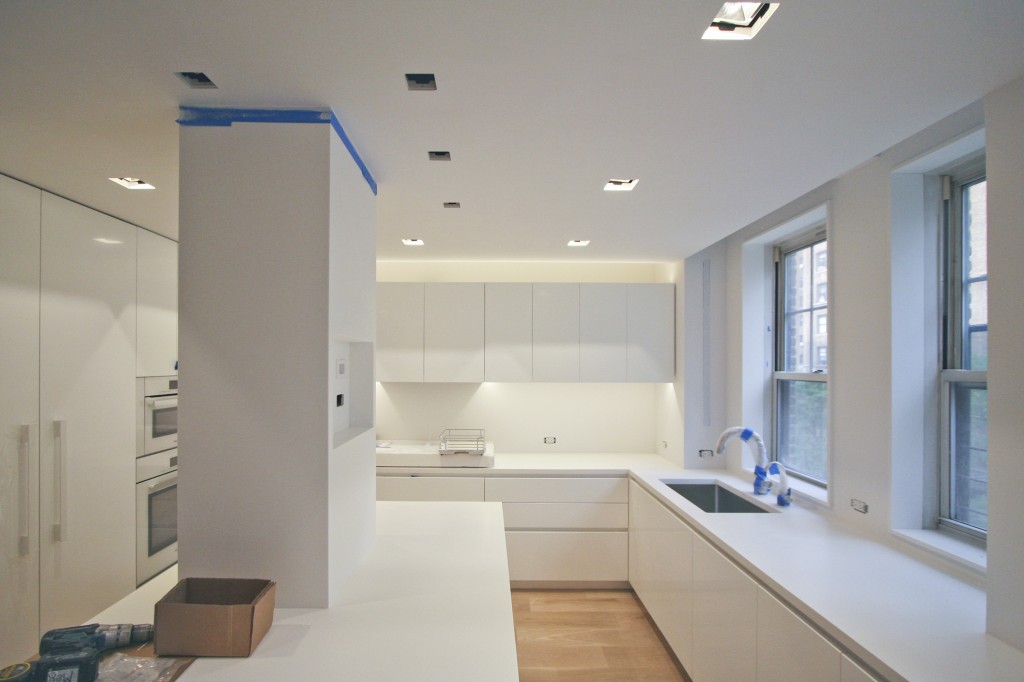   Kitchen   - a view of the kitchen island with an intersecting column and accent lighting above kitchen countertops.  