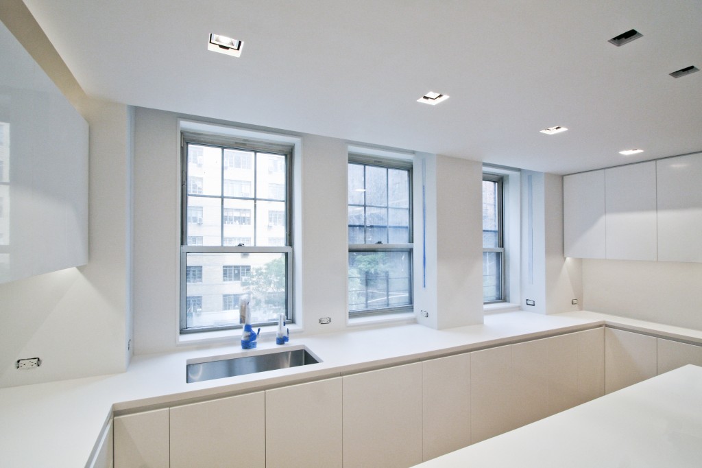 Kitchen - three windows line the new corian countertops to let in tons of natural light.