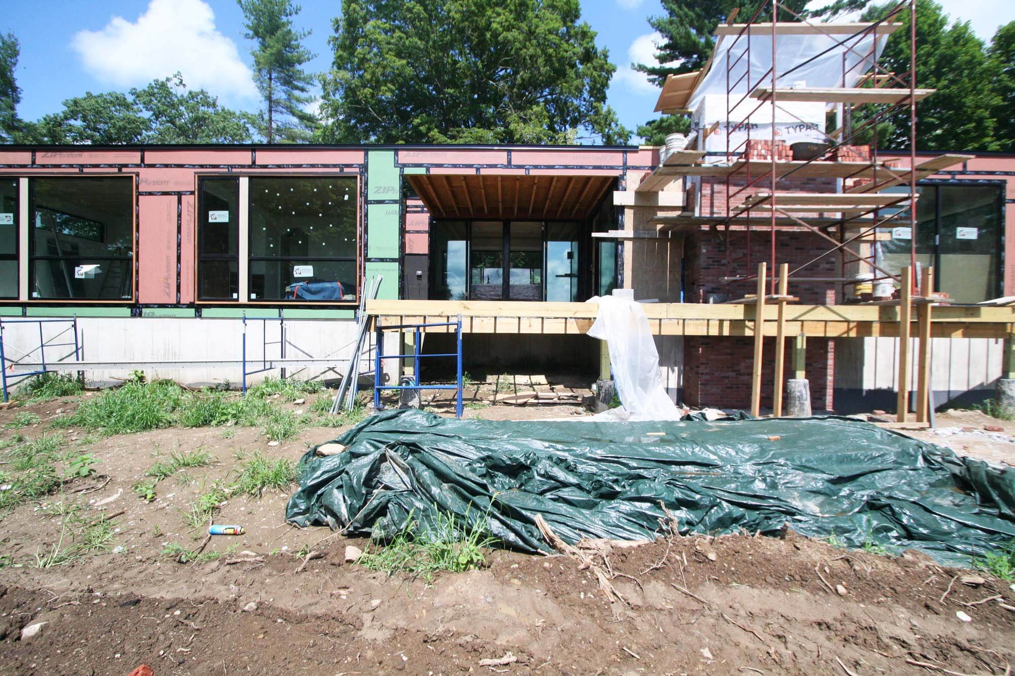 South Exterior Elevation - View of deck and brick chimney construction at rear facade