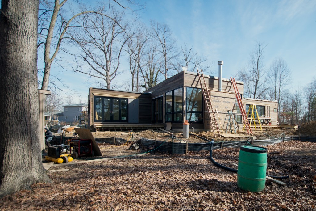   House siding nearly finished, work on fireplace cladding beginning  