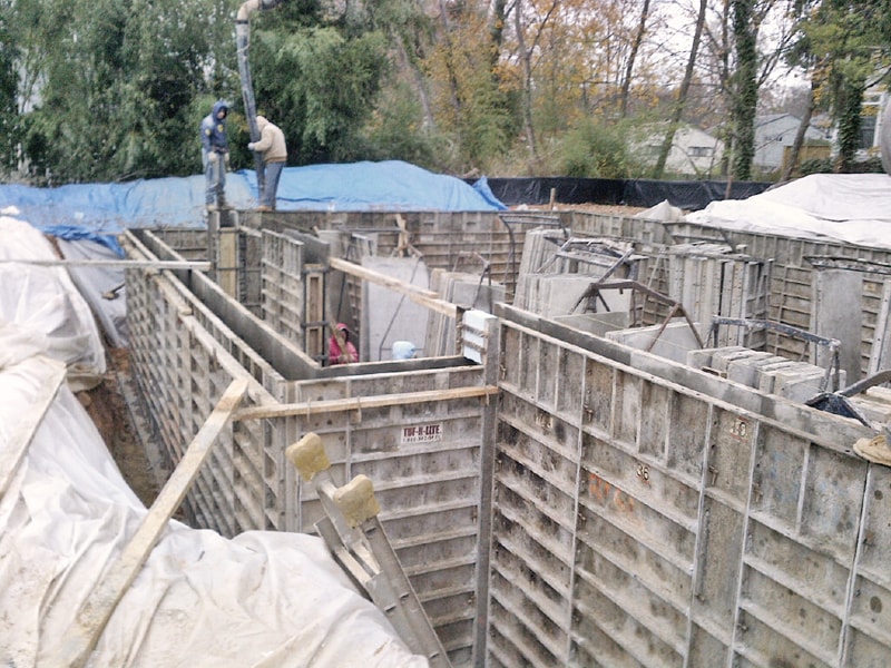   Workers constructing the formwork for the houses foundation  