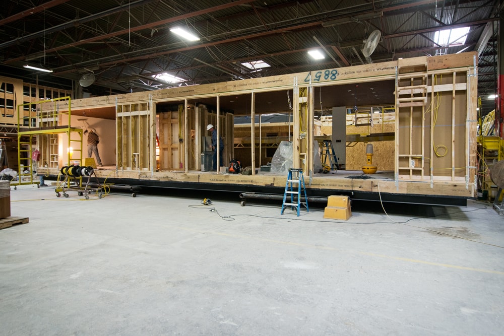   Module in factory with sheetrock being applied to the interior  