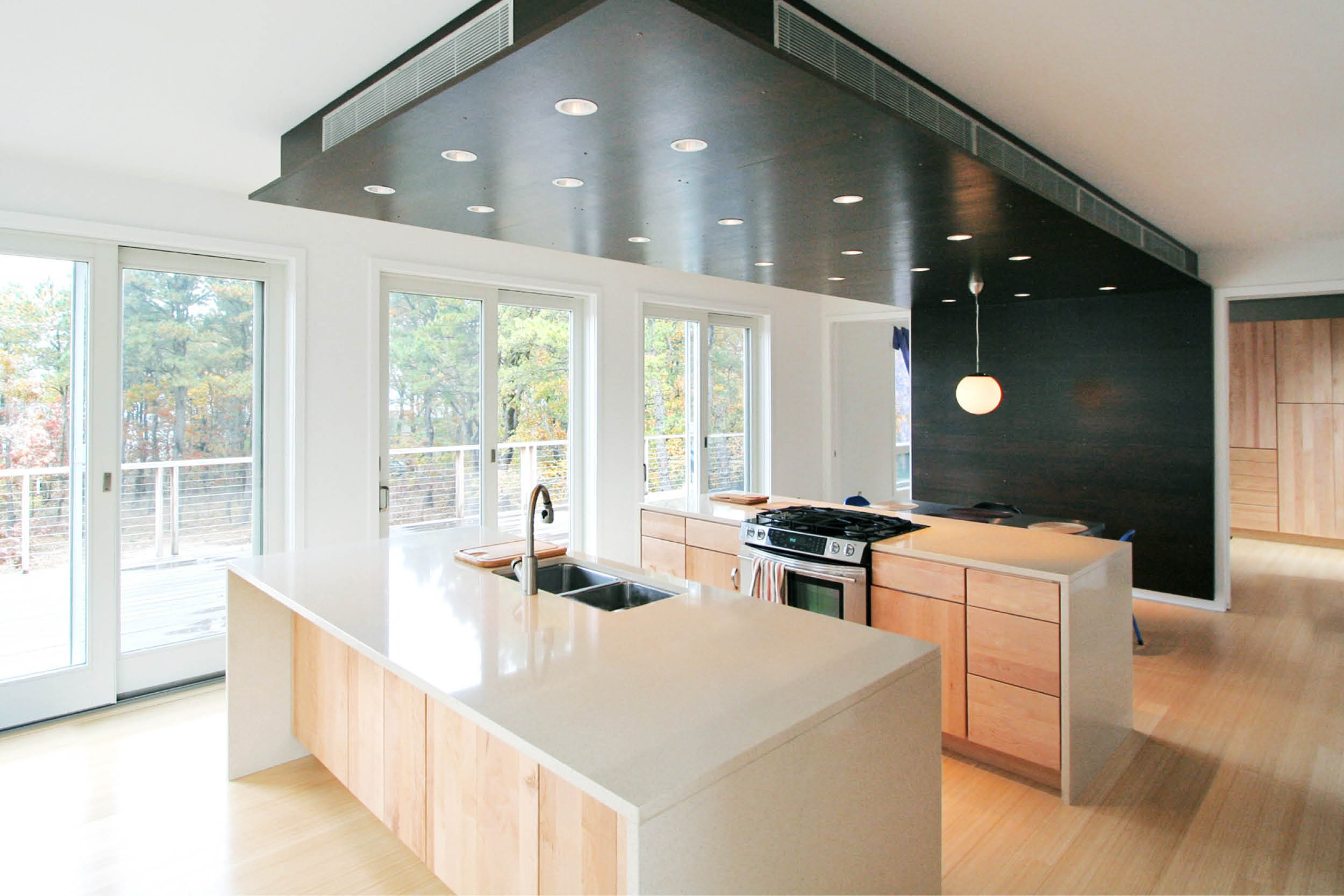 Modern Modular Prefab Peconic Bay House | Shinnecock Hills Hamptons New York | Kitchen Custom Cabinets Island Black Steel White Sliding Glass Doors | RES4