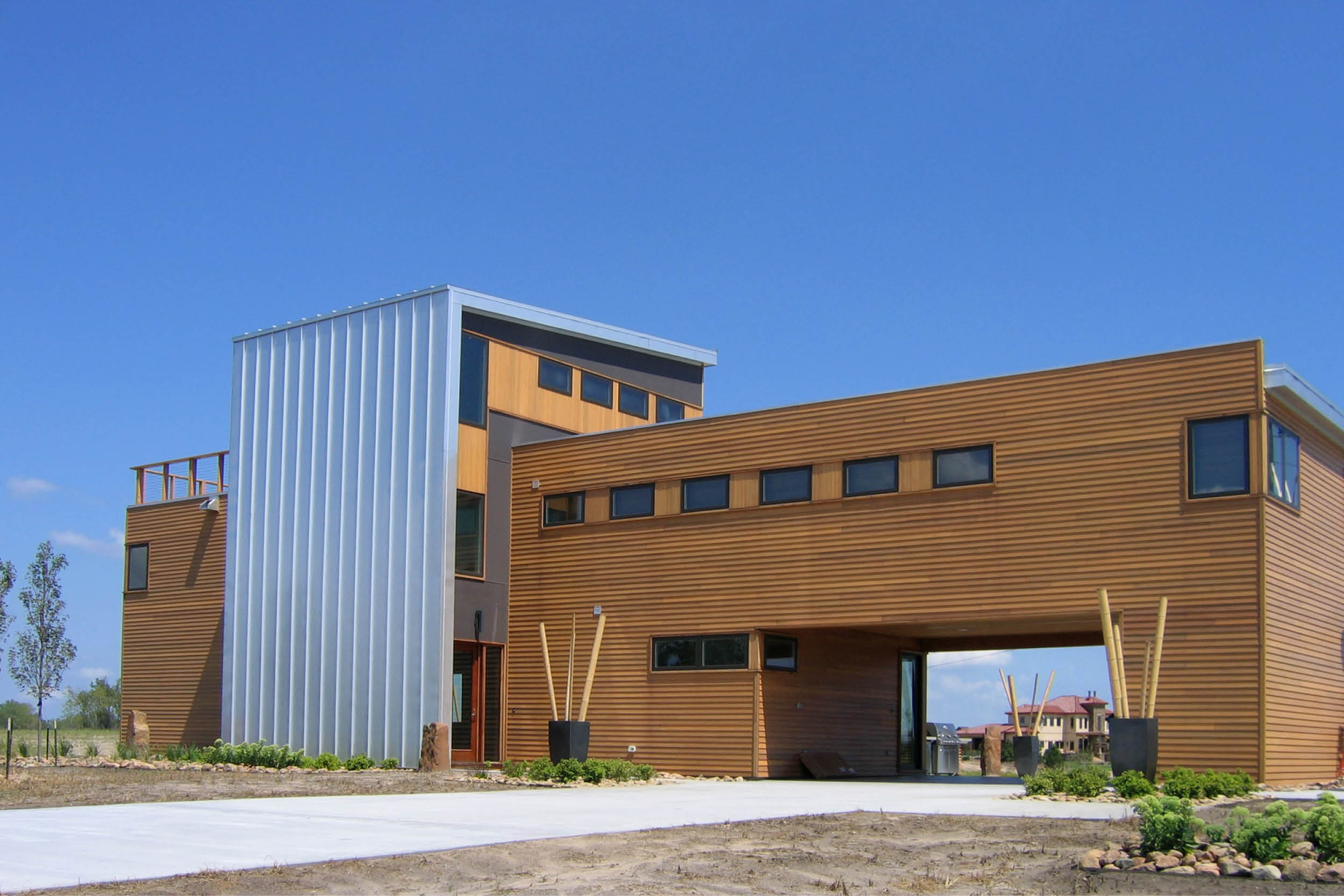 Modern Panelized Prefab Sandy Lake House | Ashland Nebraska | Cedar Siding Metal Panel Carport Roof Deck Strip Windows | RES4