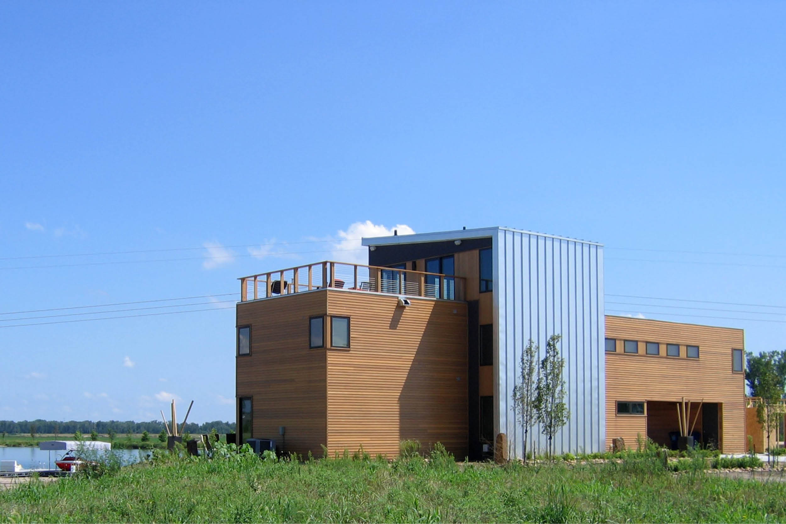 Modern Panelized Prefab Sandy Lake House | Ashland Nebraska | Cedar Siding Metal Panel Roof Deck Strip Windows | RES4