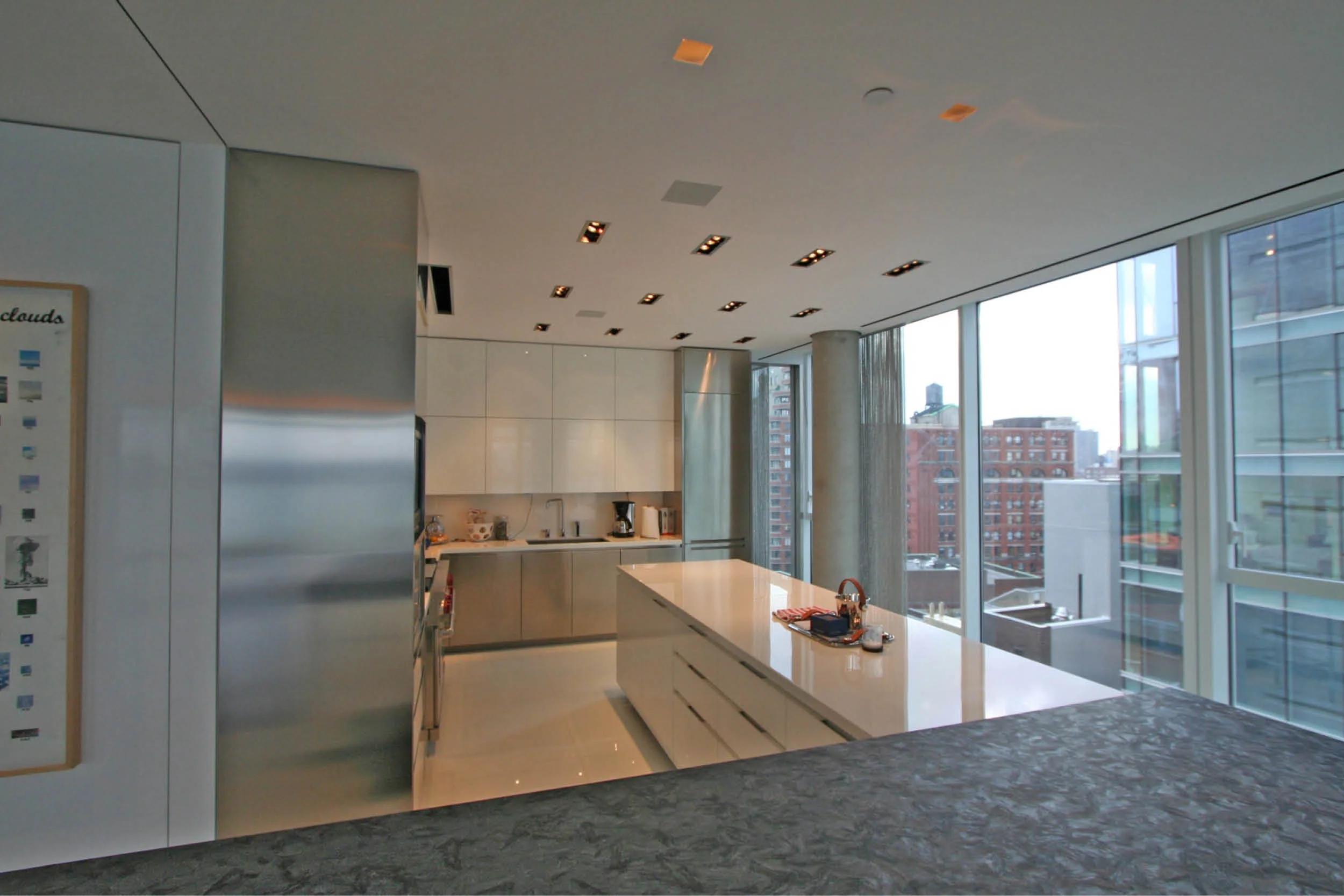 Modern Apartment Renovation | New York City | White Kitchen Concrete Columns Custom Cabinets Island Curtain Wall Windows Metal Chain Curtains | RES4