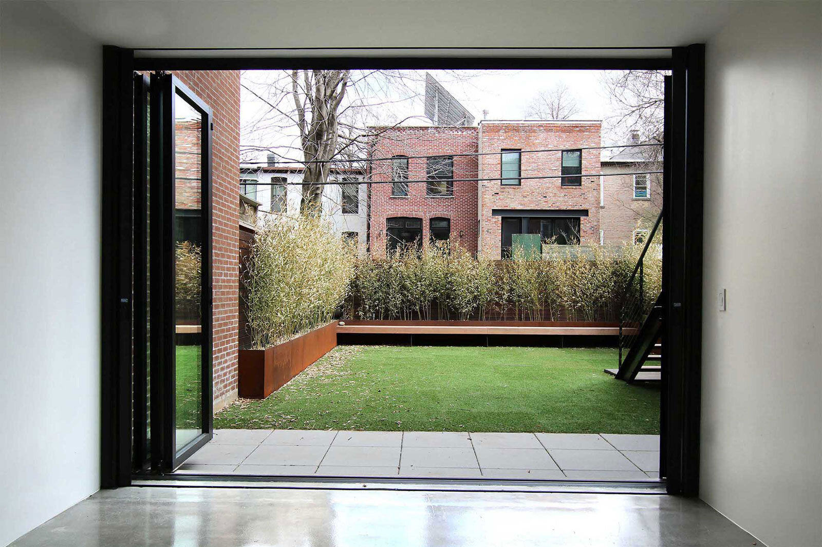 18-res4-re4a-resolution-4-architecture-park-slope-townhouse-brooklyn-modern-home-garden-level-playroom-to-backyard-artificial-turf-bamboo-planters-nanawall-folding-glass-doors.jpg
