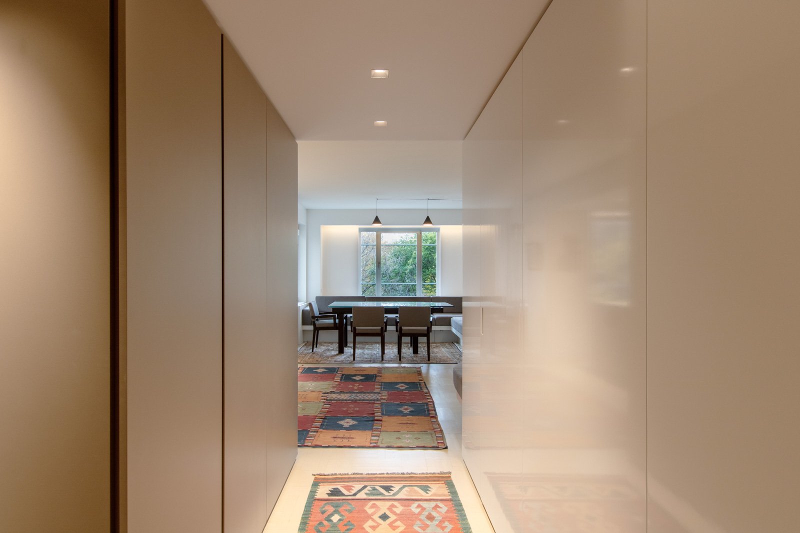 01-res4-resolution-4-architecture-modern-apartment-renovation-nyc-pied-a-terre-entry-foyer-hall-custom-millwork-hidden-doors.jpg