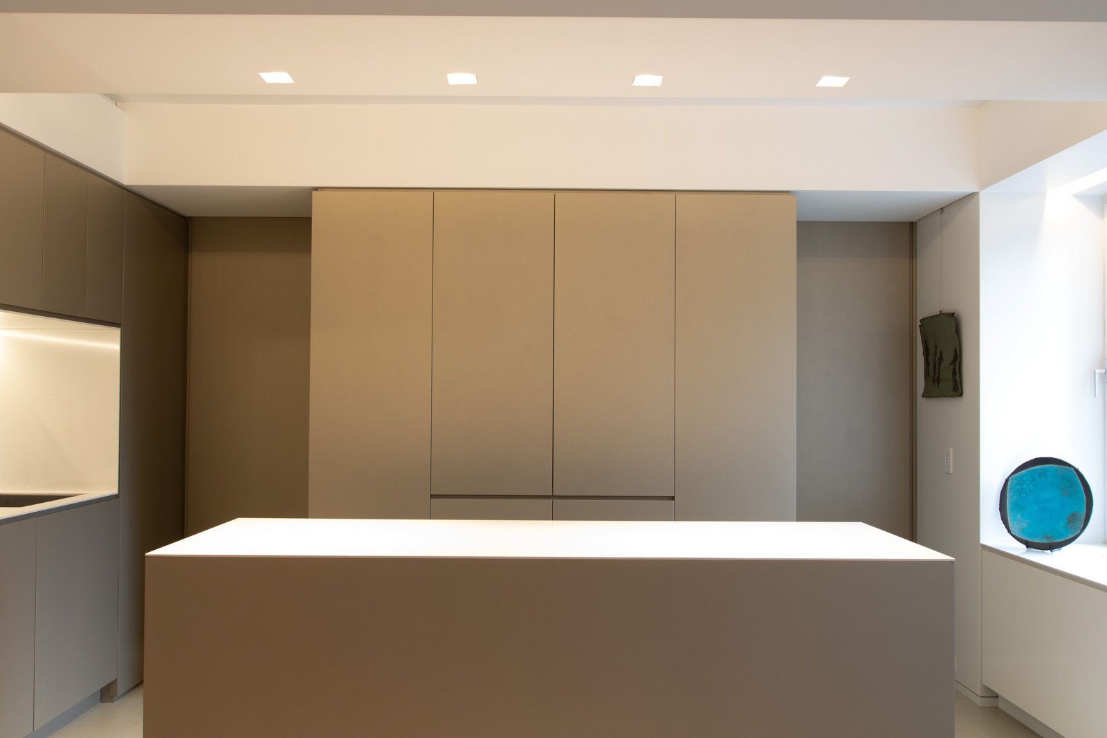 07-res4-resolution-4-architecture-modern-apartment-renovation-nyc-pied-a-terre-kitchen-custom-island-cabinets-metallic-millwork-built-ins-hidden-pocket-doors-appliance-garage.jpg