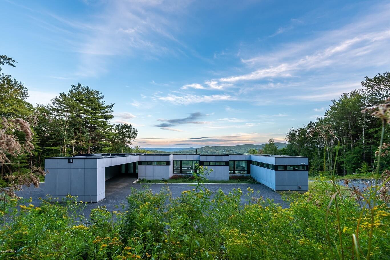 This modular prefab house in the Berkshires serves as a country retreat. Capitalizing on the modular nature of construction, the floor plan is broken into a series of volumes that slip in the landscape, providing opportunities for a courtyard deck, p