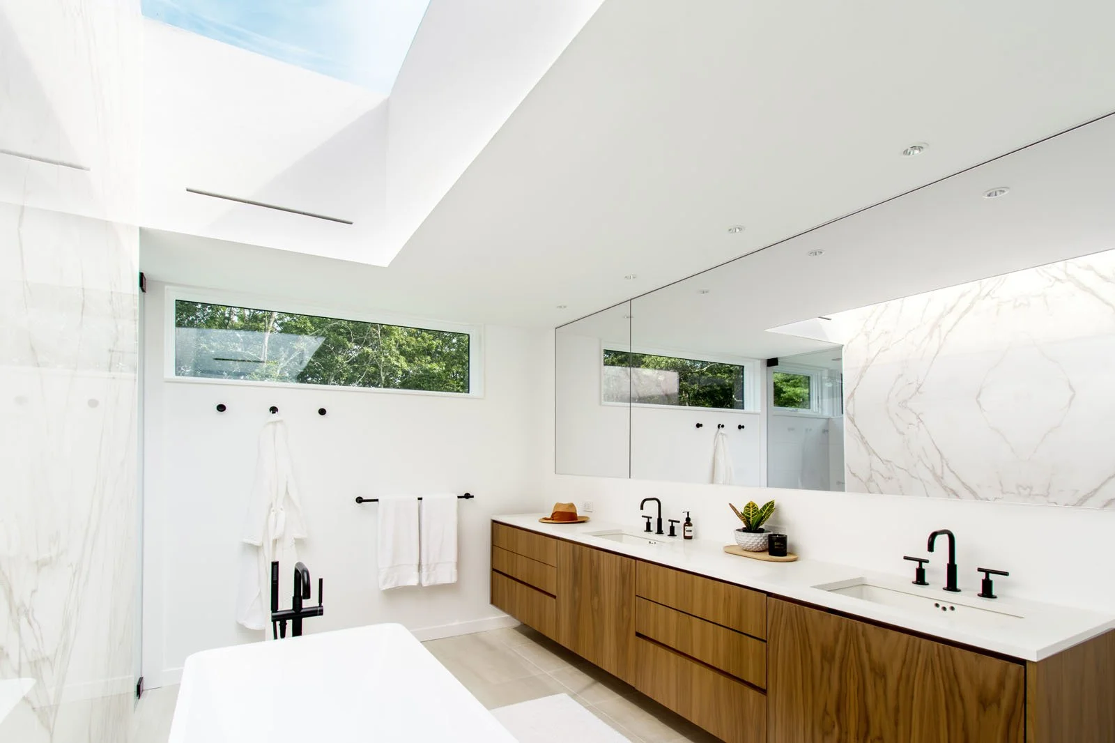 custom-modern-modular-prefab-hamptons-home-ny-architects-primary-bathroom-design-skylight-walnut-vanity-summer-house