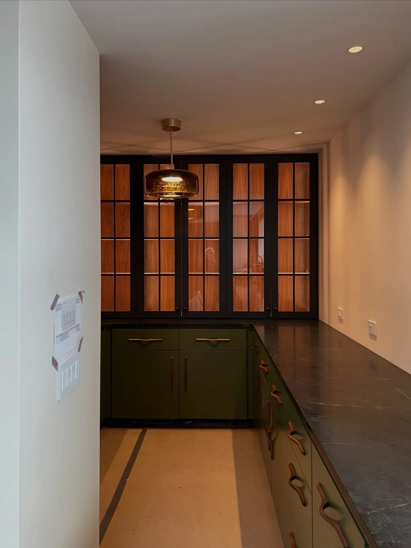 We&rsquo;re nearing completion at Cutchogue Bluff House! These photos highlight custom walnut and green painted cabinetry &mdash; crafted with intent to balance warmth, daylight, and material tactility. Integrated lighting punctuates key moments in p