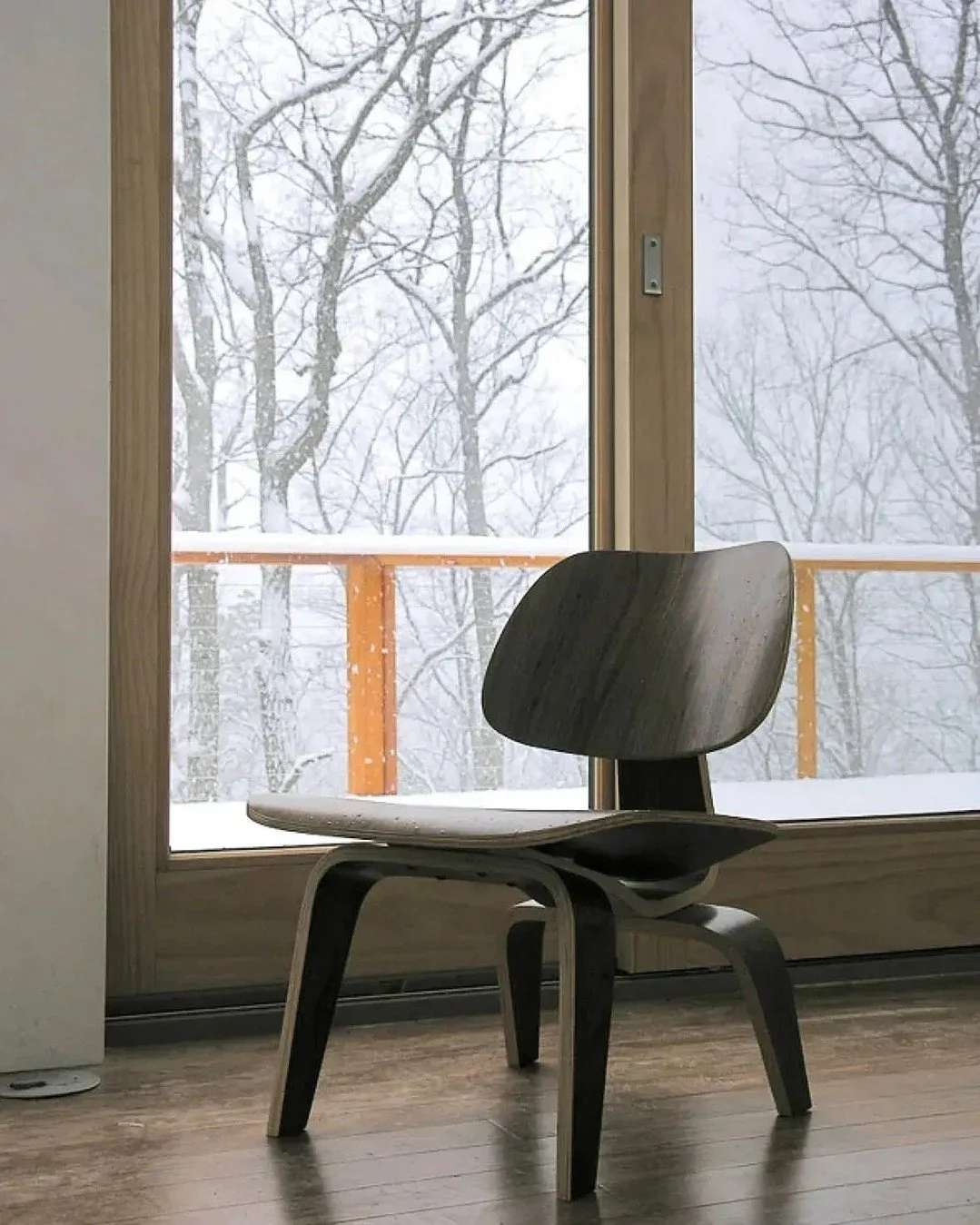 The starkness of winter can foster pause.

A classic molded Eames chair set against the snow and pines. 

In Lost River, West Virginia - just a couple hours from D.C. - the quiet of the woods and the warmth of crafted materials meet in stillness: the