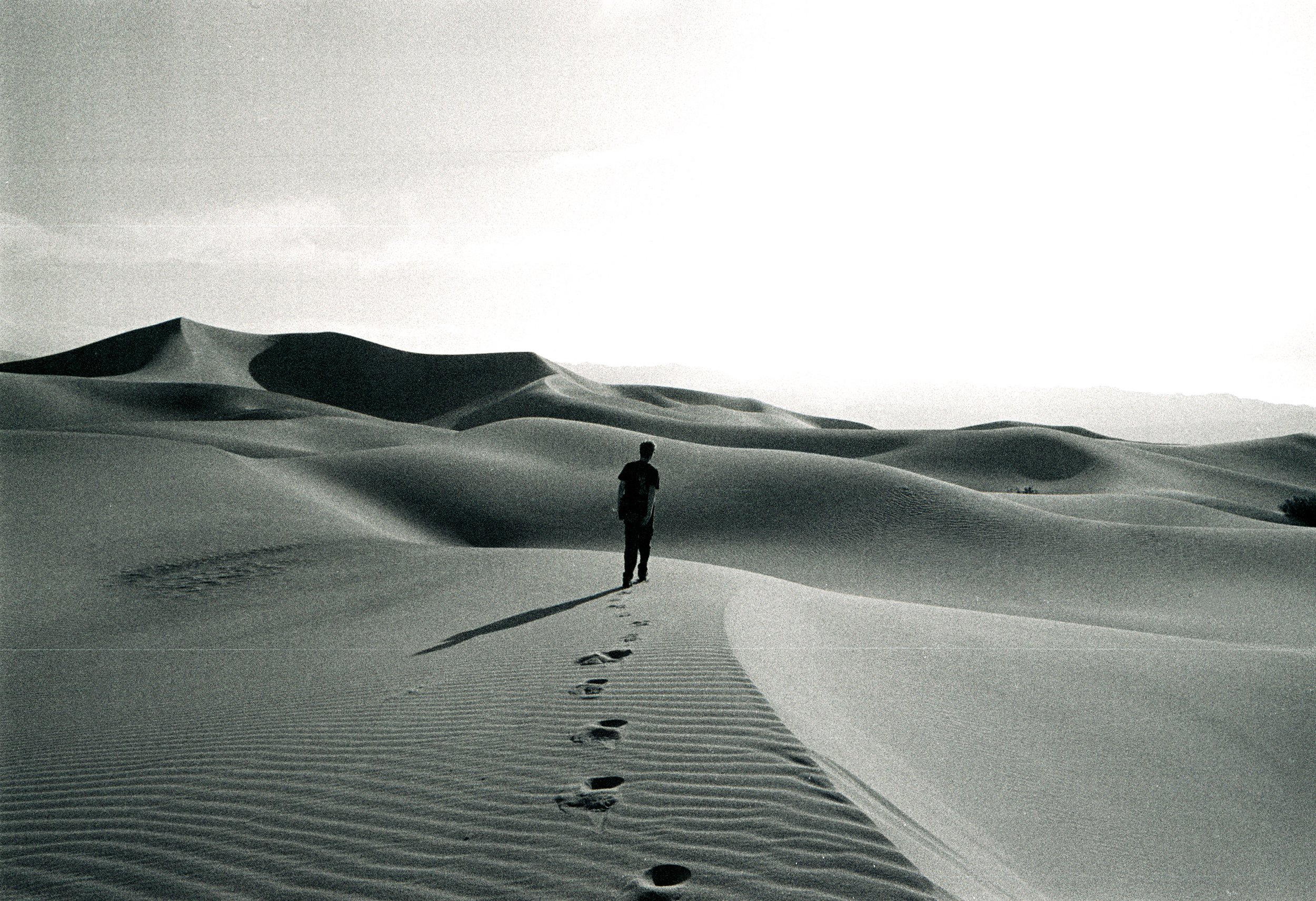 Boaz Walks toward Sun Sand Dunes Death Valley Dunes B&W Nikon F Film.jpg