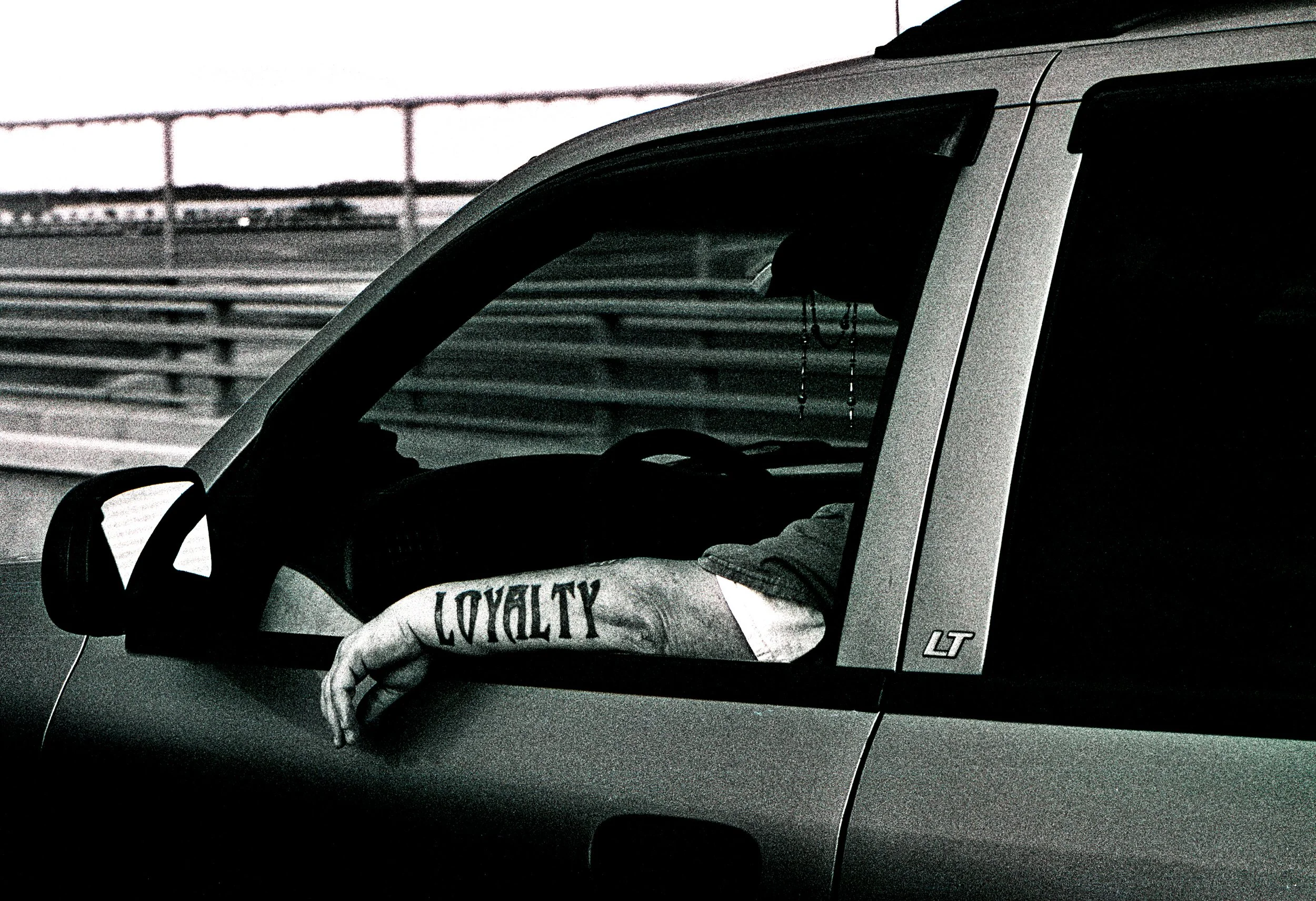 Loyalty Arm Tattoo out Window NYC B&W Film Official.jpg