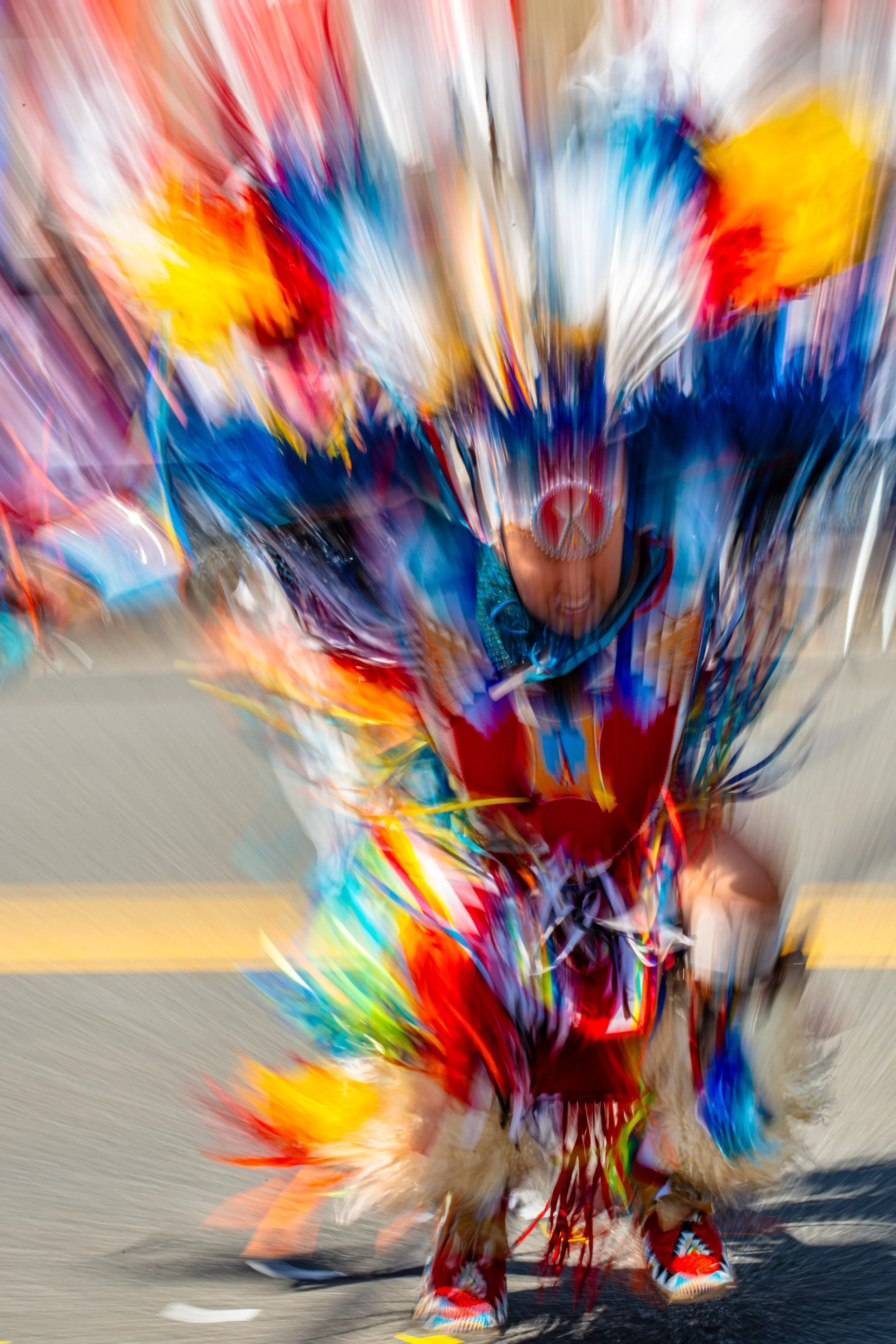 Traditional Native American attire with a feathered headdress, vibrant colorful clothing, and accessories, cultural celebration dance.