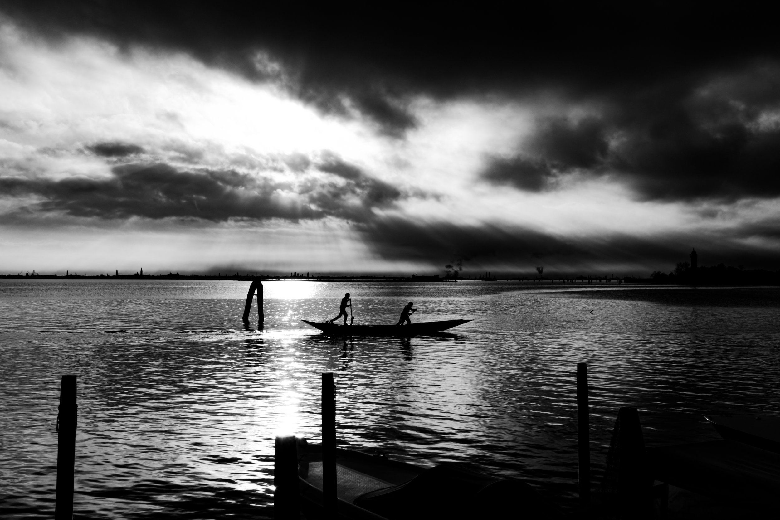 Silhouettes of two people on a boat Venice Italy