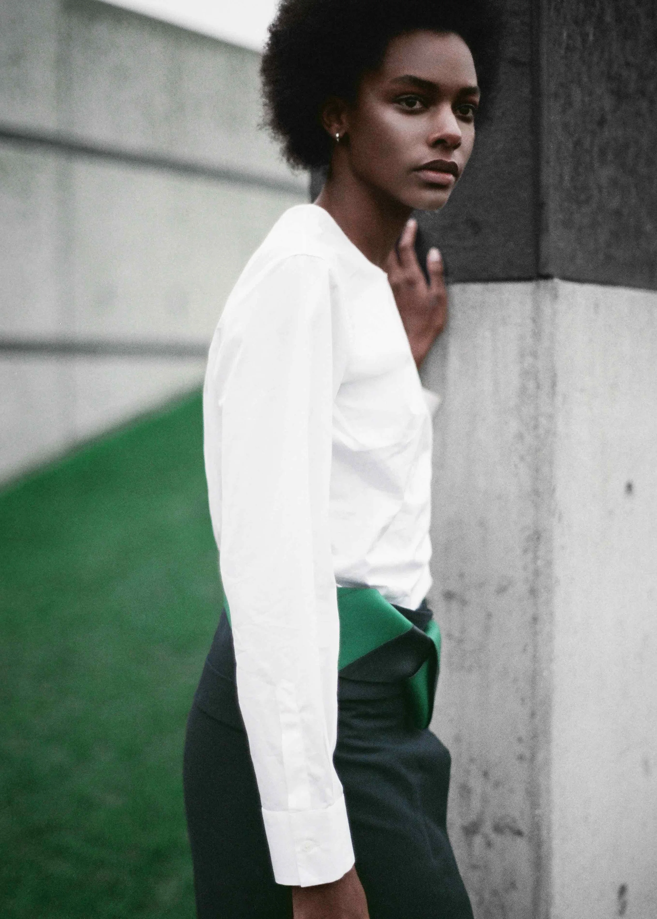White cotton poplin shirt, cotton gabardine wrap skirt, navy and green leather belt, calf leather socks and sandals. 