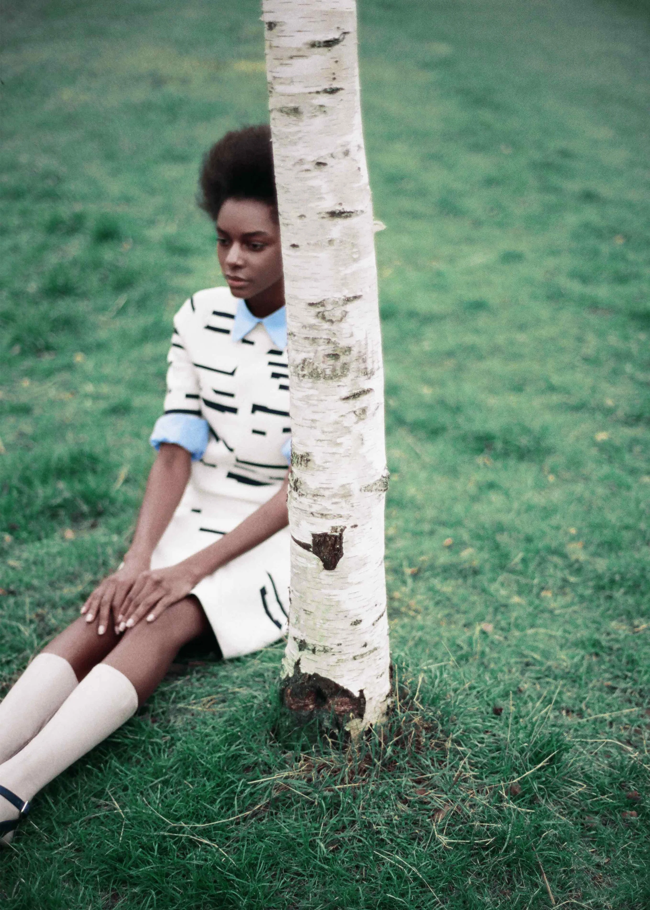 Short sleeved jacquard sweater and skirt, blue cotton poplin shirt, calf leather socks and sandals.