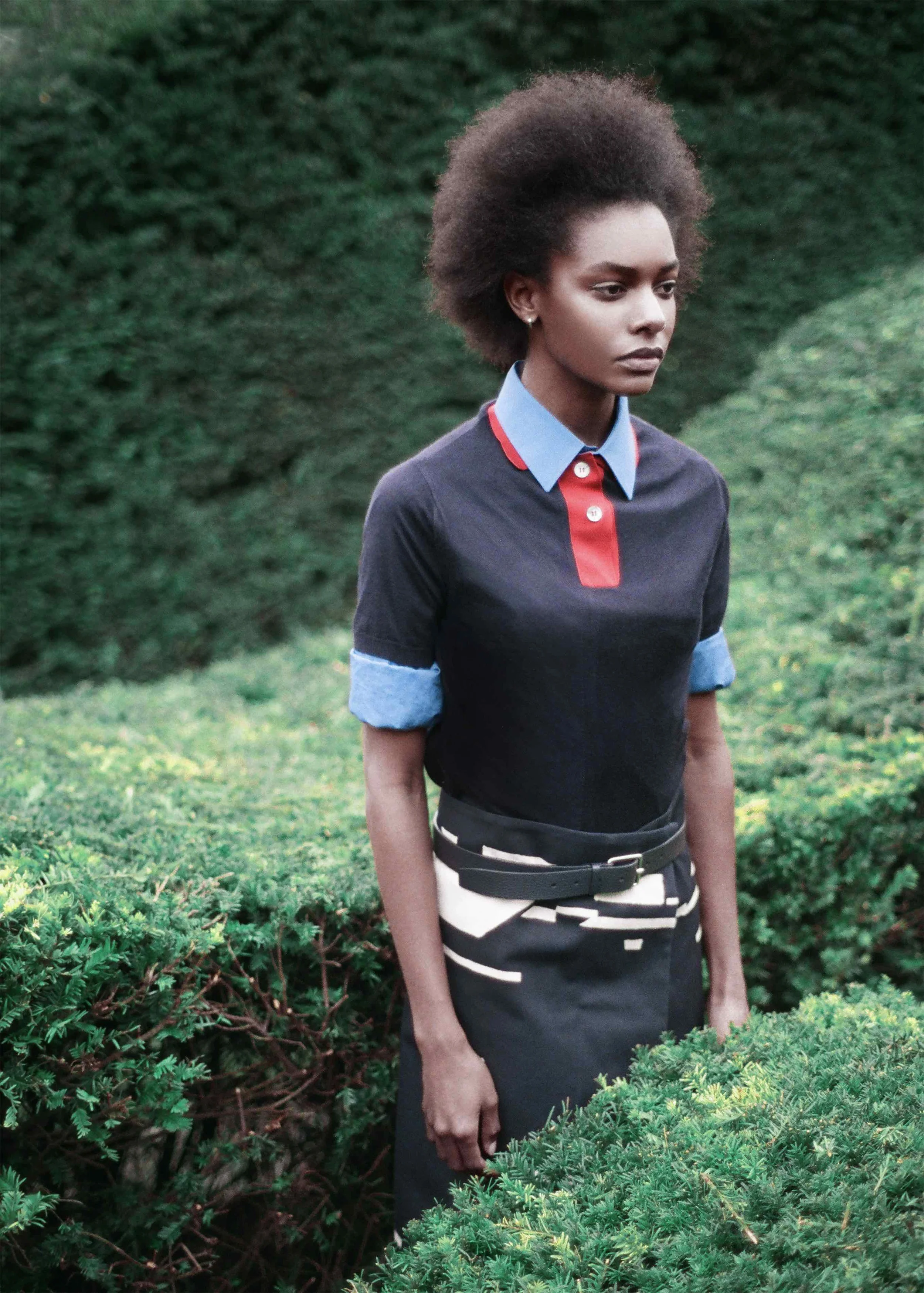 Navy cashmere polo, blue cotton poplin shirt, jacquard navy skirt, calf leather belt. 