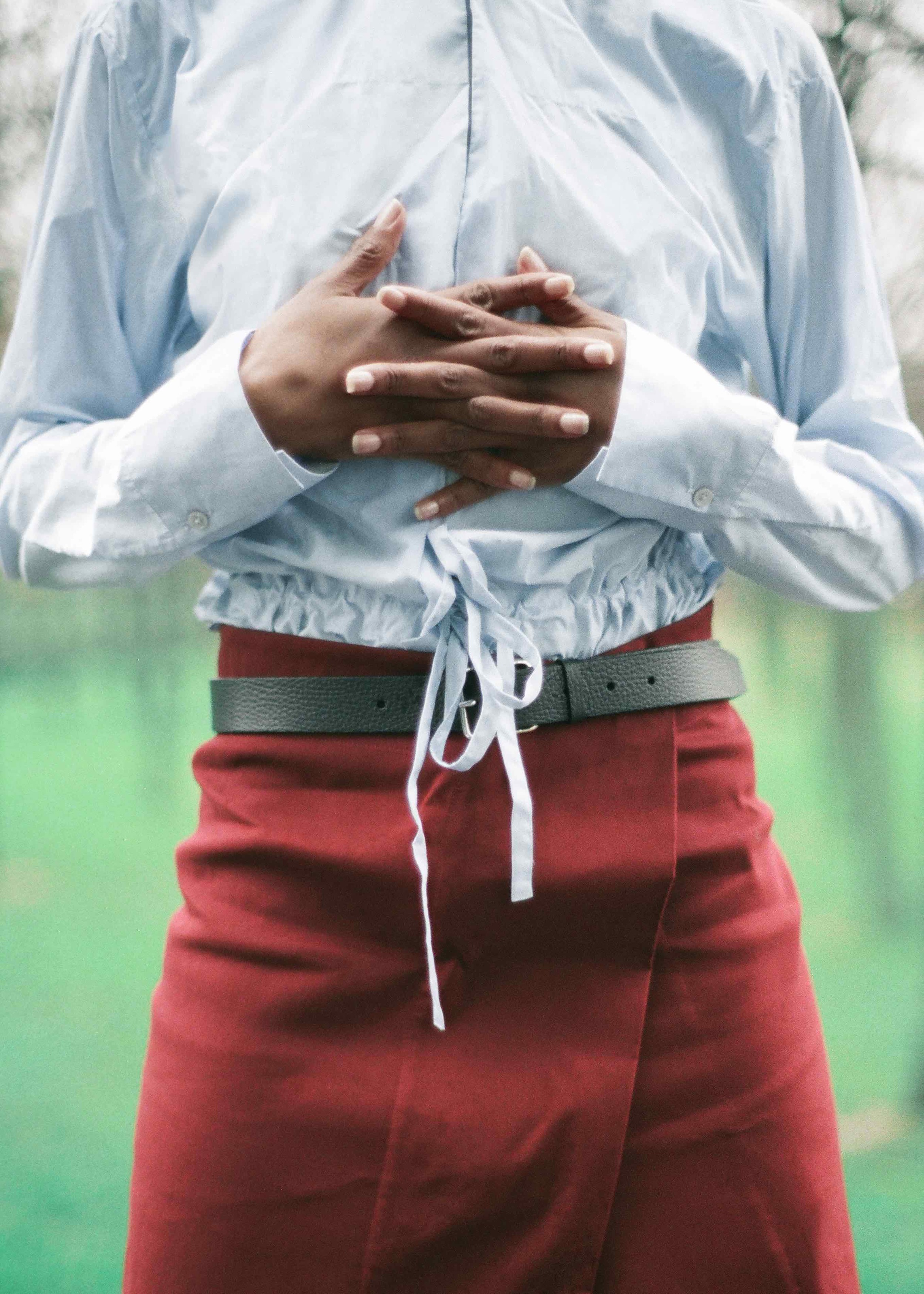  Blue cotton poplin shirt, cotton gabardine wrap skirt, calf leather belt.&nbsp; 