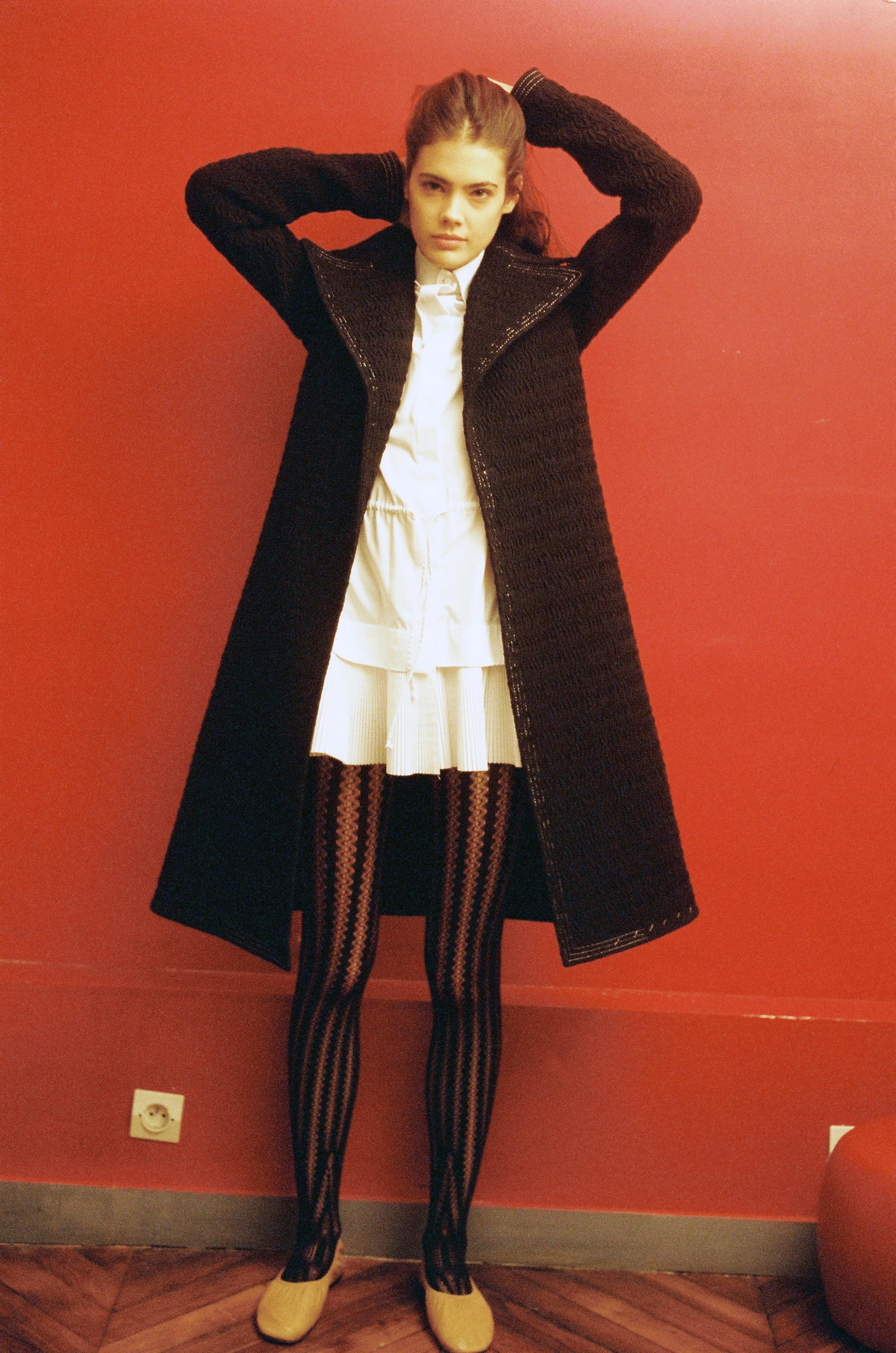  Smocked nylon coat  CÉLINE,  woven cotton pleated chemisier  ALAÏA,  tights  WOLFORD,  lambksin ballerinas  CÉLINE.  