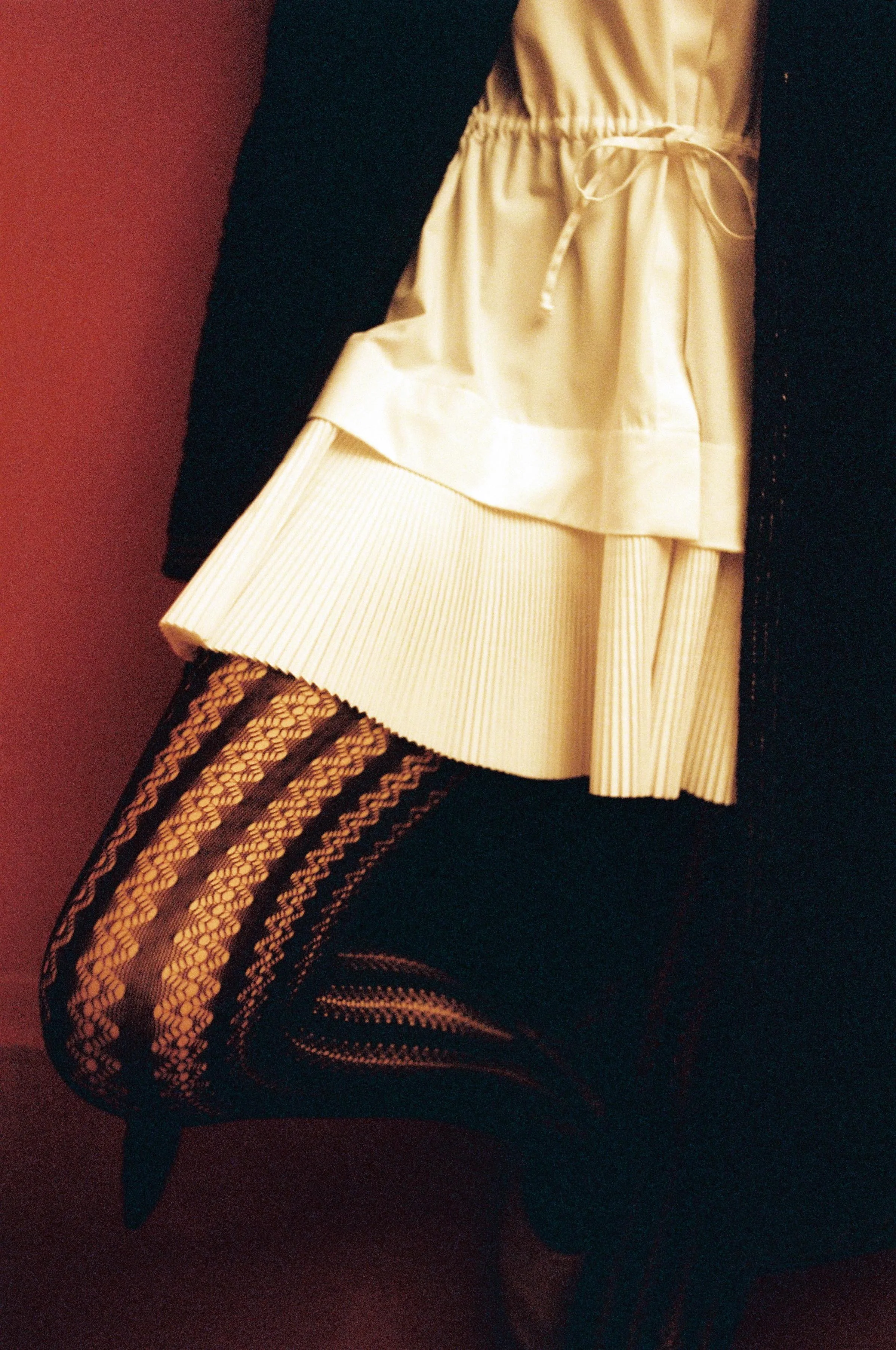 Smocked nylon coat CÉLINE, woven cotton pleated chemisier ALAÏA, tights WOLFORD, lambksin ballerinas CÉLINE.
