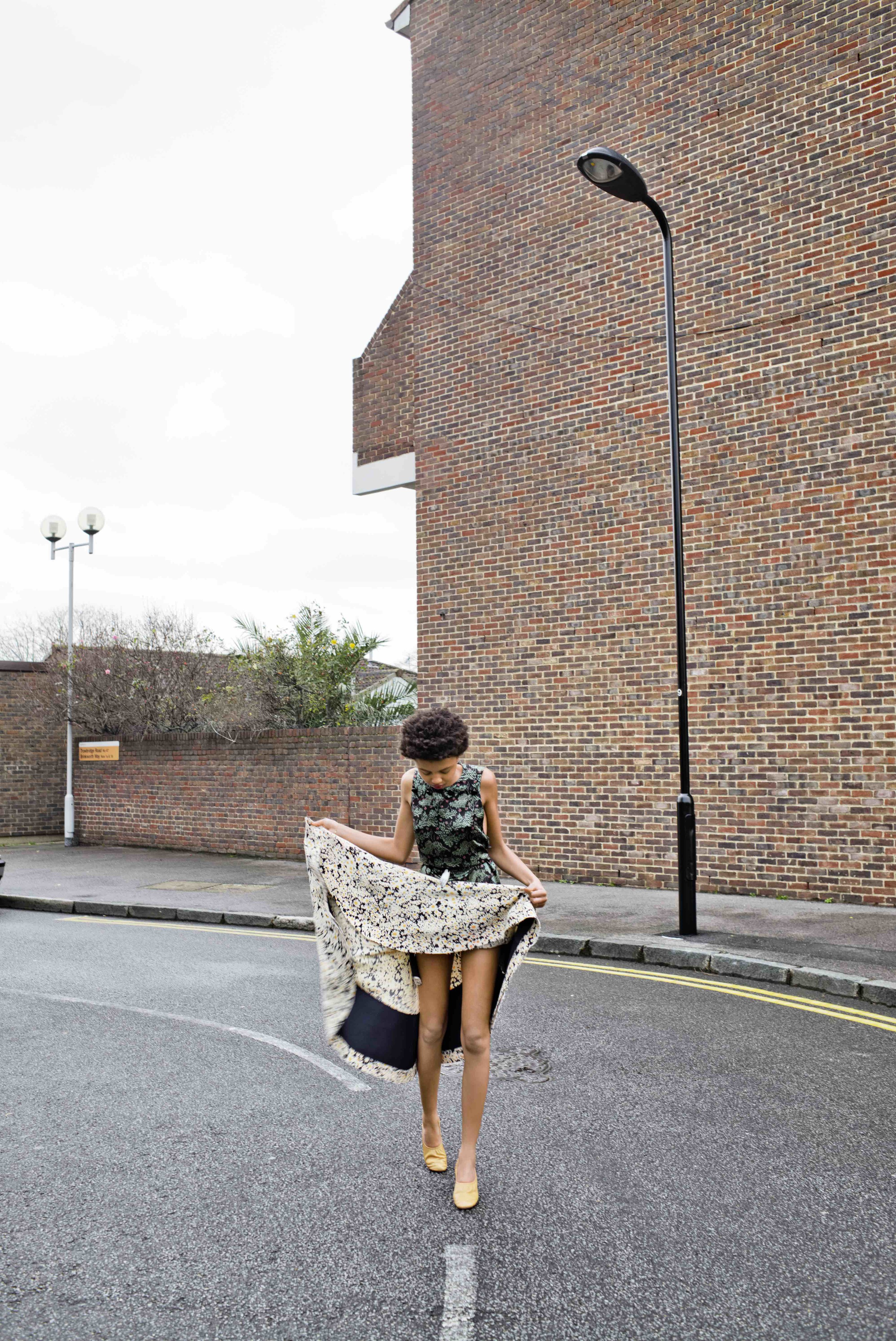  Silk floral printed top and asymmetrical skirt, body hand belt and tan lambskin ballerina pumps. 