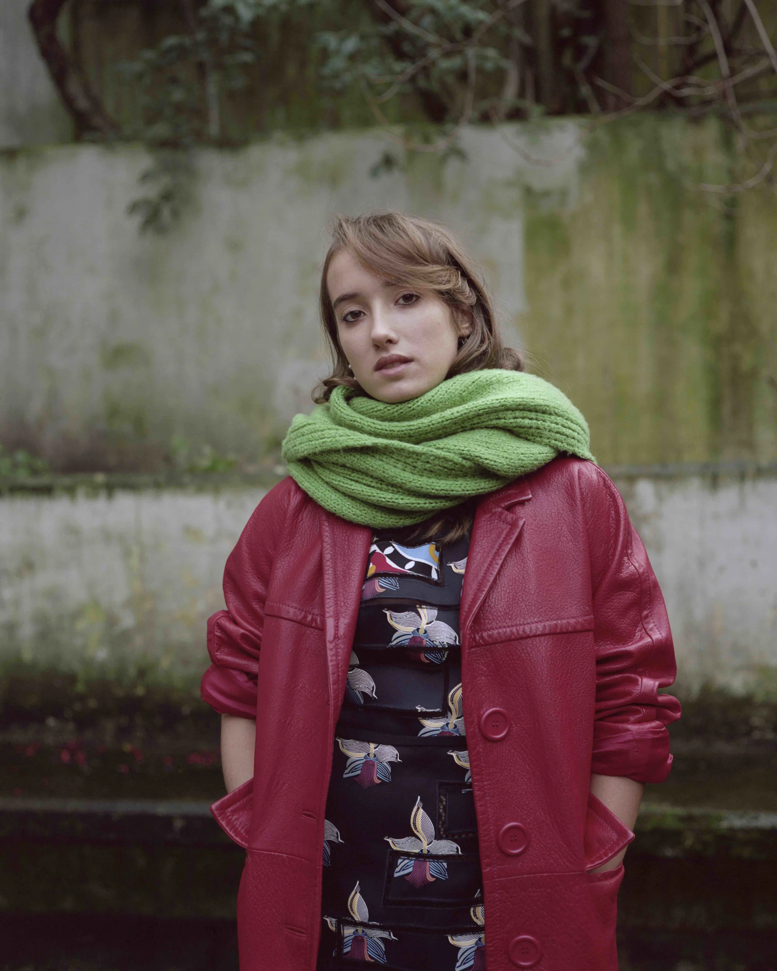 Nappa red leather coat MIU MIU , silk orchid print dress FENDI, knit wool scarf Leonetta’s own.