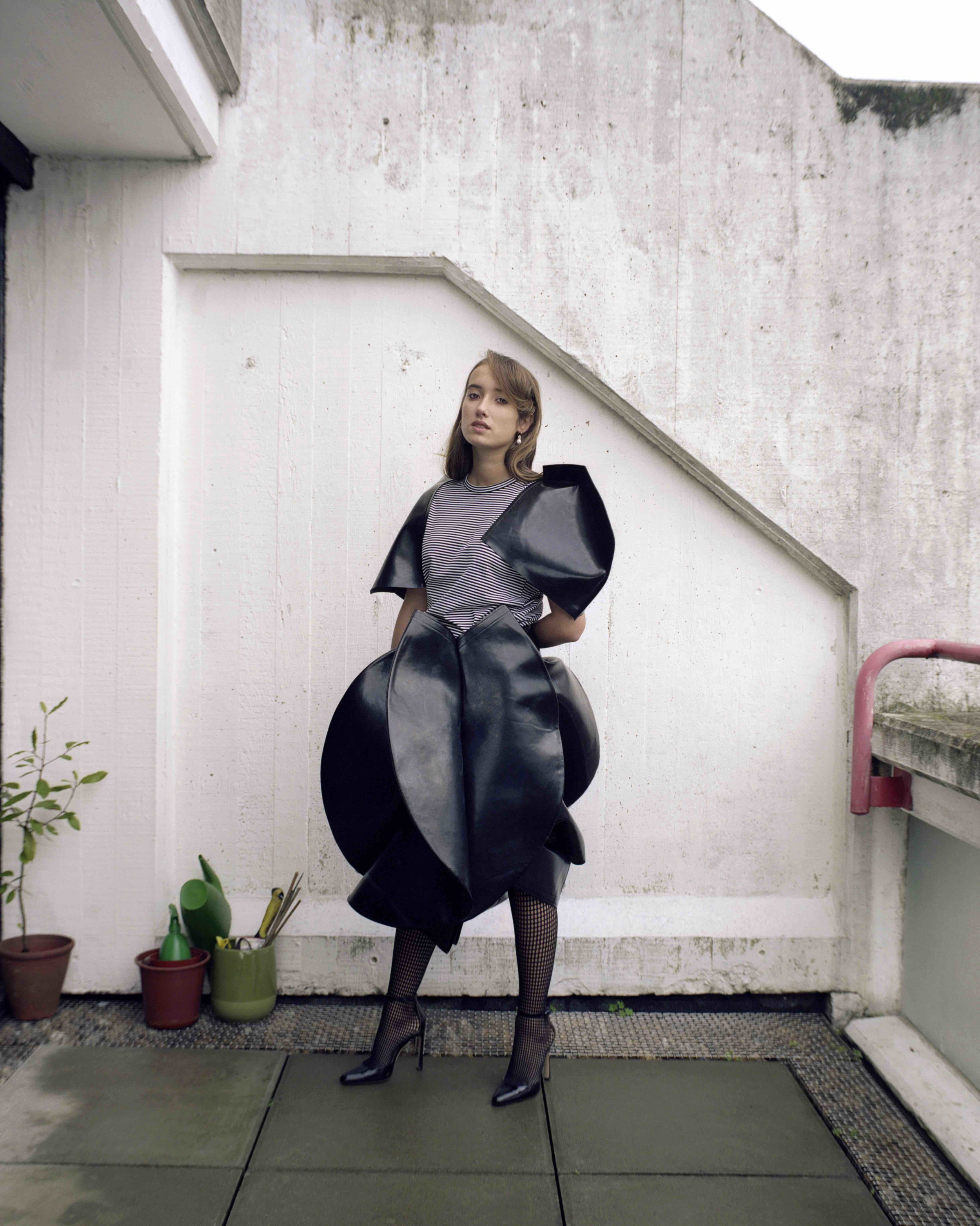  Striped black vinyl top and skirt  JUNYA WATANABE , black tights  WOLFORD , gold cluster hoops with white pearls  SWEET PEA JEWELLERY . 