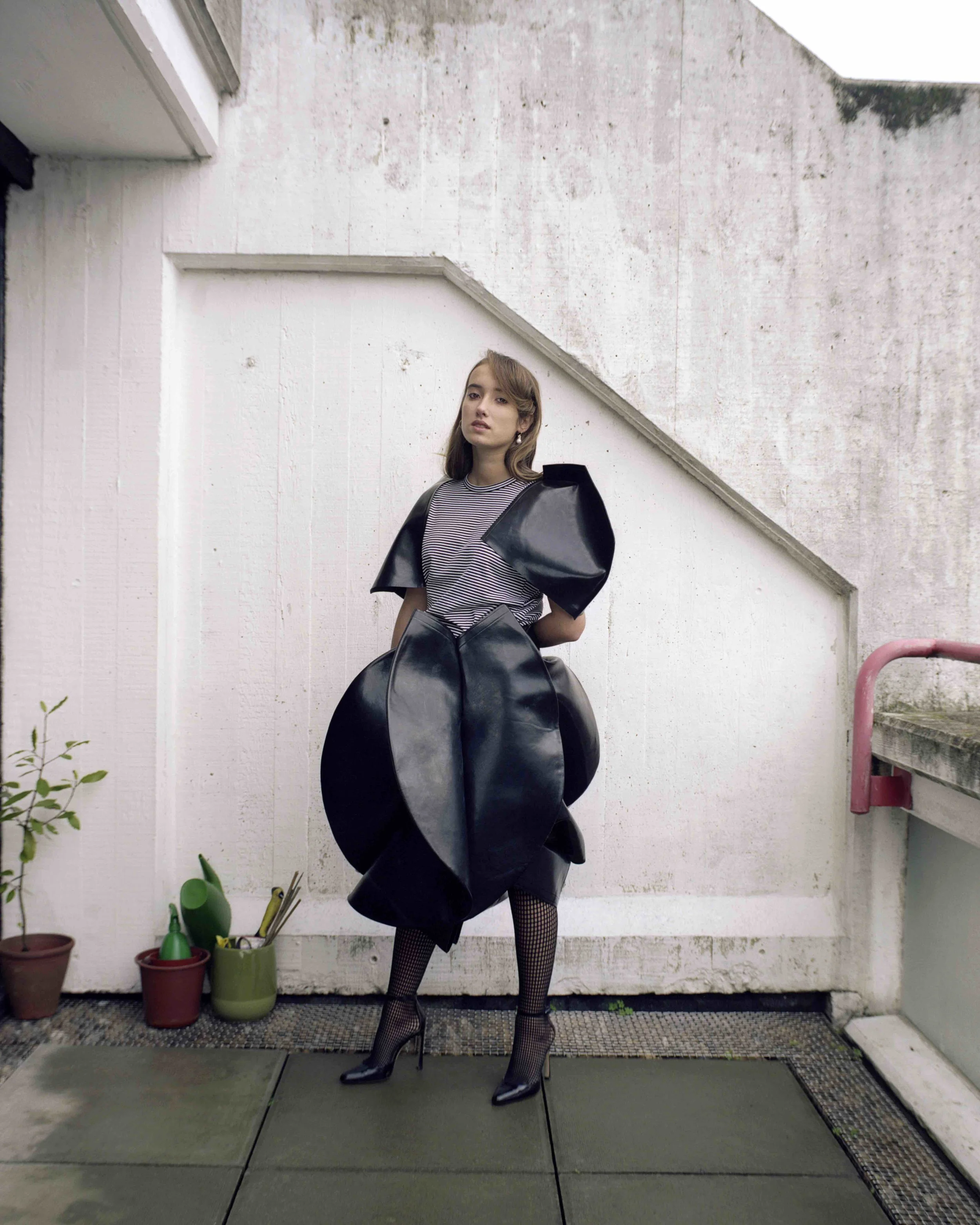 Striped black vinyl top and skirt JUNYA WATANABE , black tights WOLFORD , gold cluster hoops with white pearls SWEET PEA JEWELLERY .