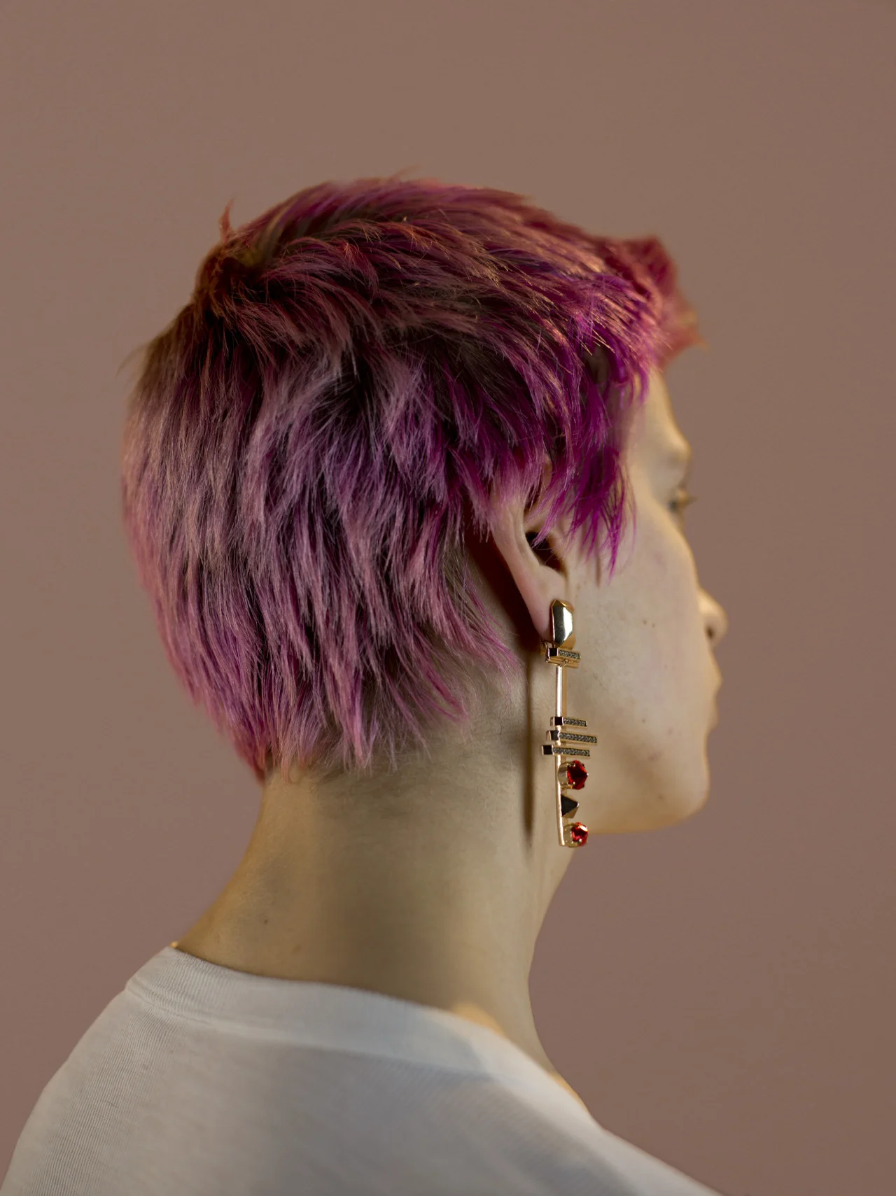 Goldplated geometric earring with red fused stones, long sleeve thermal vest stylist’s own.