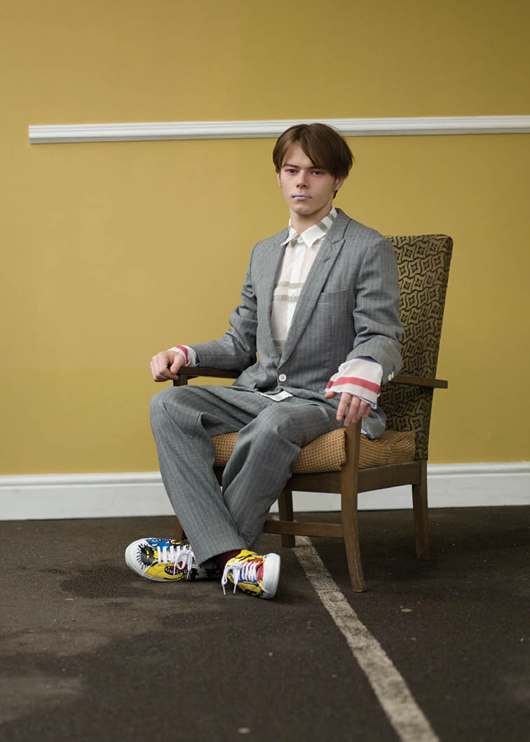  Striped mohair and wool grey jacket, white shirt with multicolored stripes, striped grey pants and hand painted canvas plimsolls. 