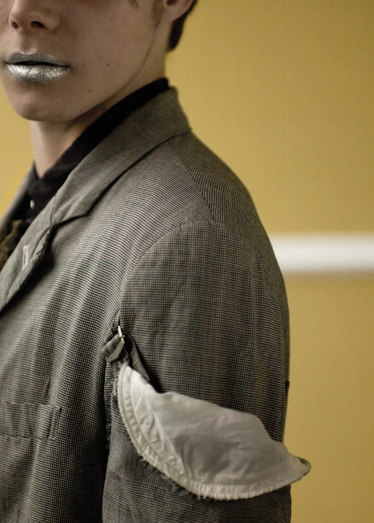 Glen check wool jacket with sleeve detail and black cotton shirt with ruffled front.