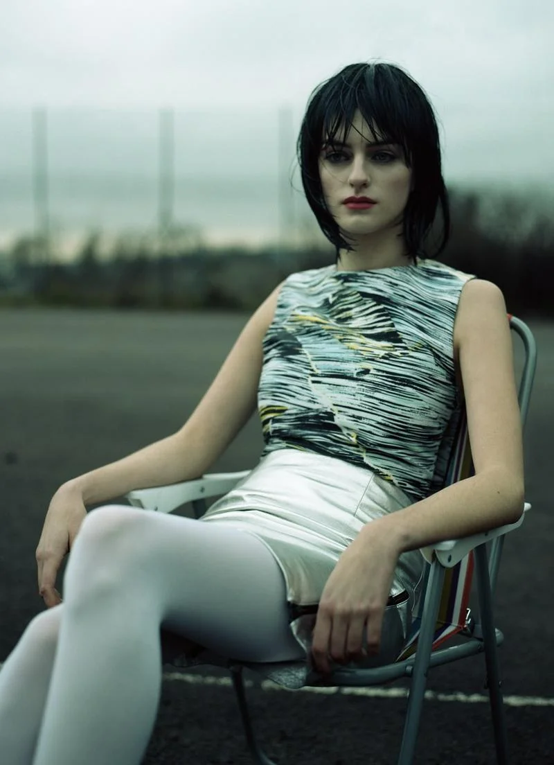 Black broken waves dress by KENZO , silver leather skirt with zip detail by HAIZHEN WANG , white tights stylist's own.