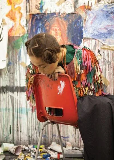 Multicolour leather fringe jacket BAS KOSTERS , green silk top and flared denim trousers VALENTINO .
