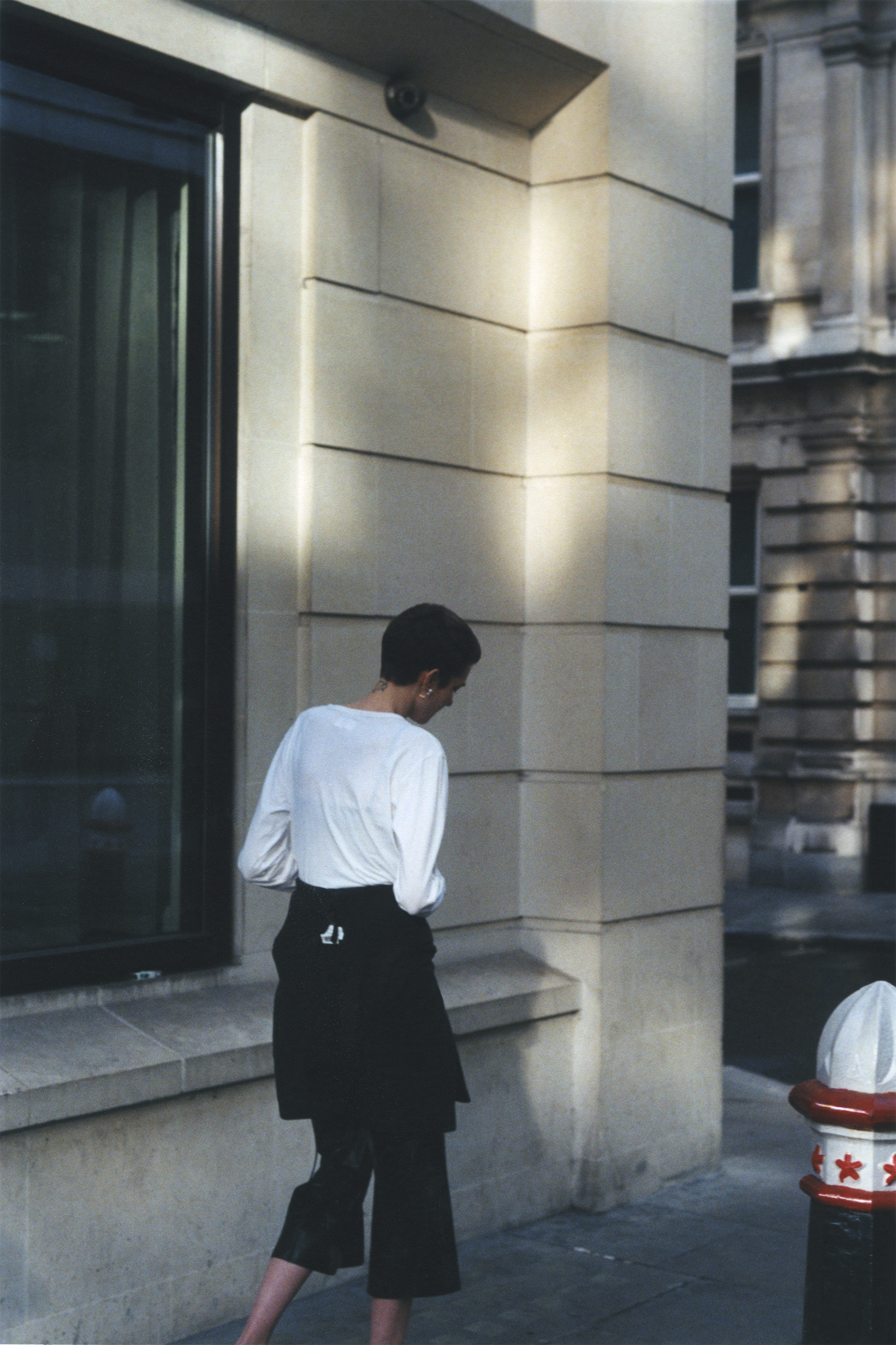 White top RON DORFF, black hoodie JOYRICH, leather flare trousers CÉLINE, sandals BALENCIAGA.