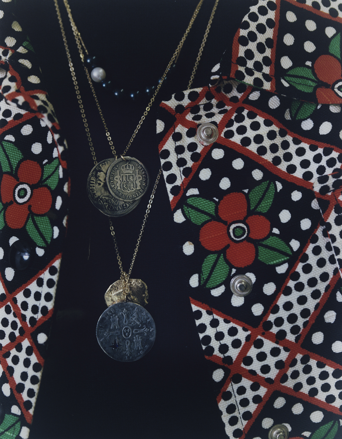  Coin necklace with midnight blue sapphire, and two coin set necklace both LAURA LEE JEWELLERY, black and white pearls necklace SWEETPEA JEWELLERY, floral printed jacket FRANCO JACASSI VINTAGE DELIRIUM, black stitched turtleneck PRADA. 
