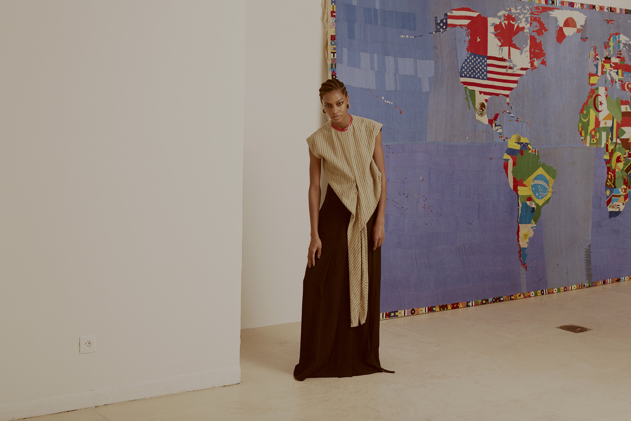  Alighiero Boetti, Mappa, 1989-94.  Striped cotton wool top, wrap long silk canvas skirt and silver brass earrings CÉLINE, diamonds and pink sapphires golden bracelet COMPLETEDWORKS. 