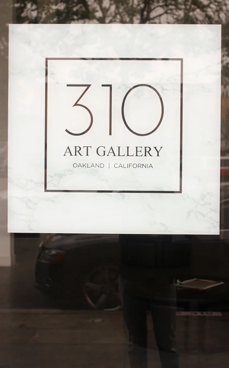 Outside window, gallery sign, and my boyfriend-fit jeans.