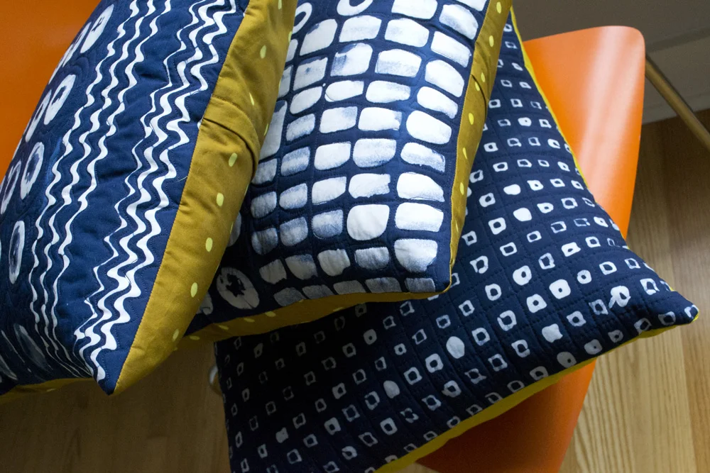 A stack of indigo dyed and patterned pillows, ready for their close-ups.
