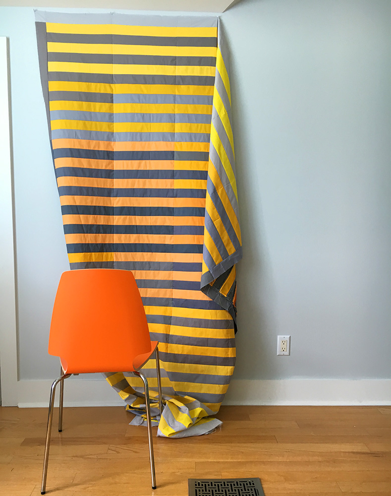 I can tack up and photograph a queen size quilt on the wall behind where my sewing machine usually lives.