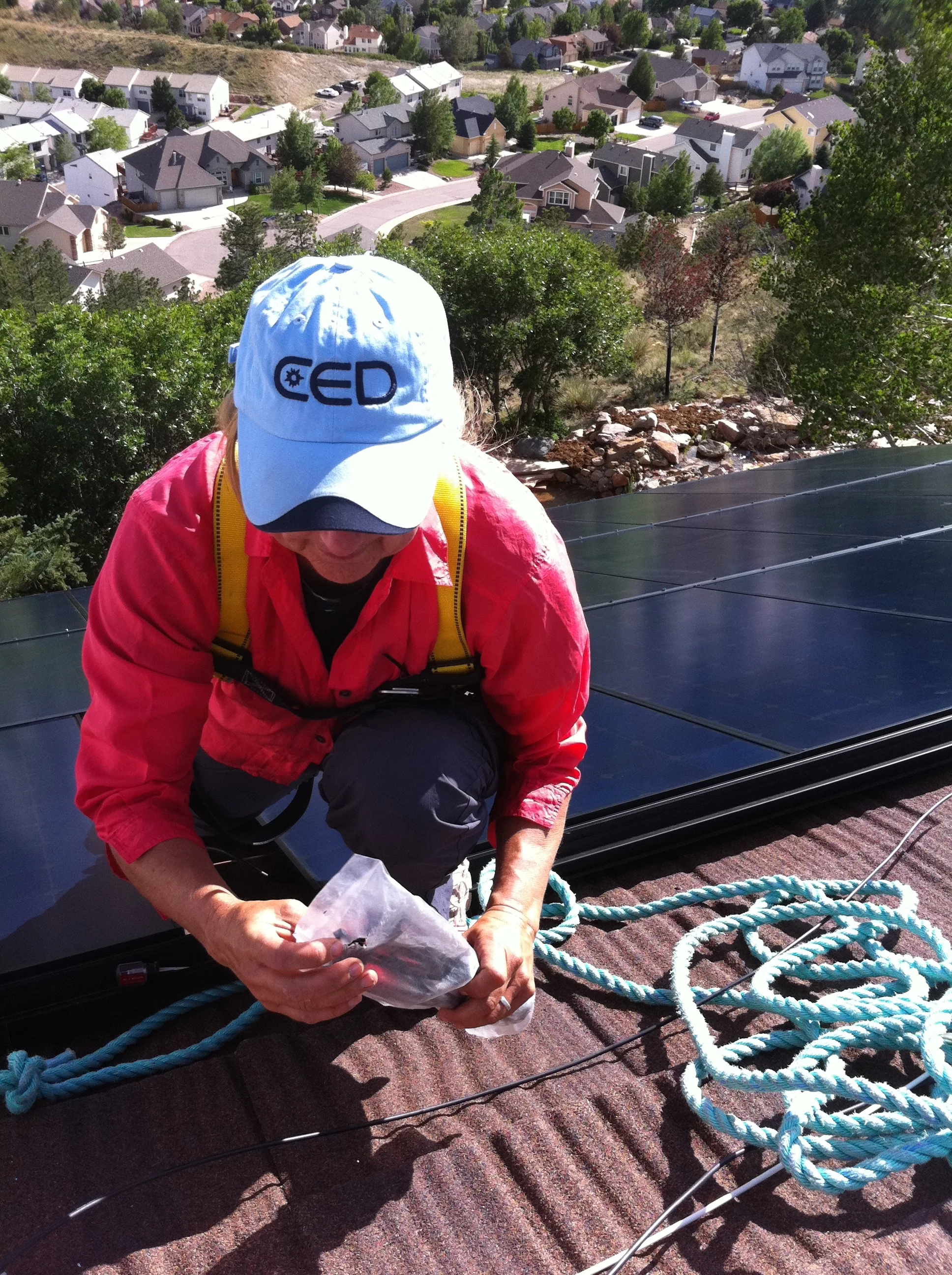 JoElyn Working on Panels on Roof.jpg