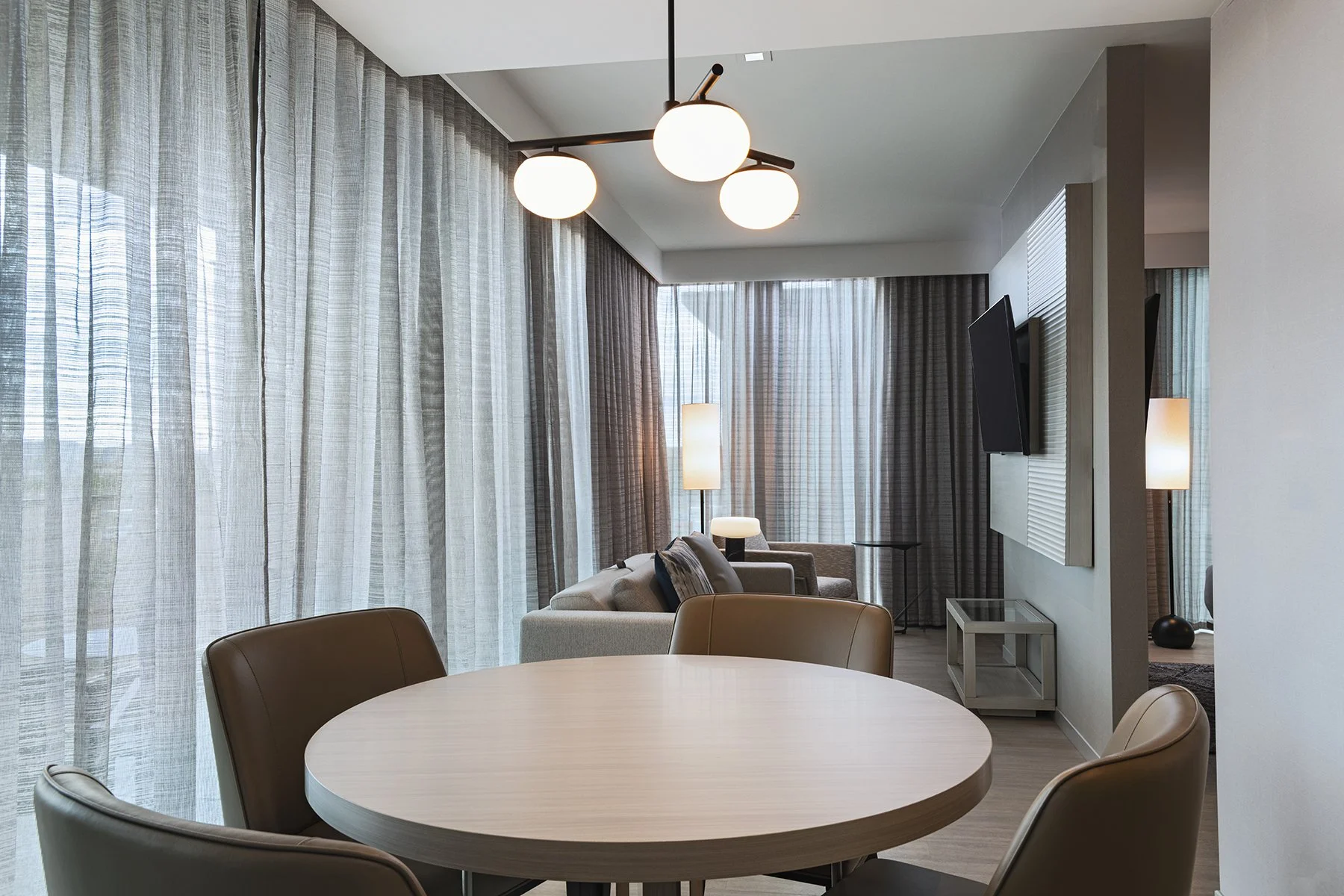 AC suite with king bed dining and living area.jpg