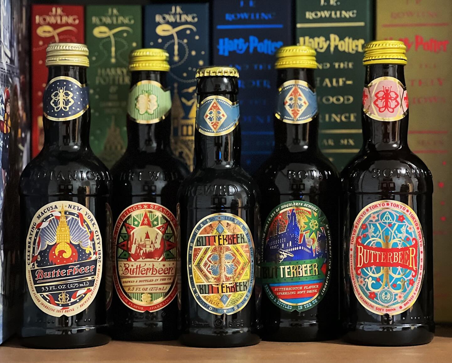 All five #MinaLima-designed #butterbeer bottles to-date, from left to right:

&bull;MaCUSA (New York Exclusive) available only at @harrypotterny, released 2021
&bull;Christmas Edition, released 2022
&bull;Primary Design, released 2020
&bull;Celebrati