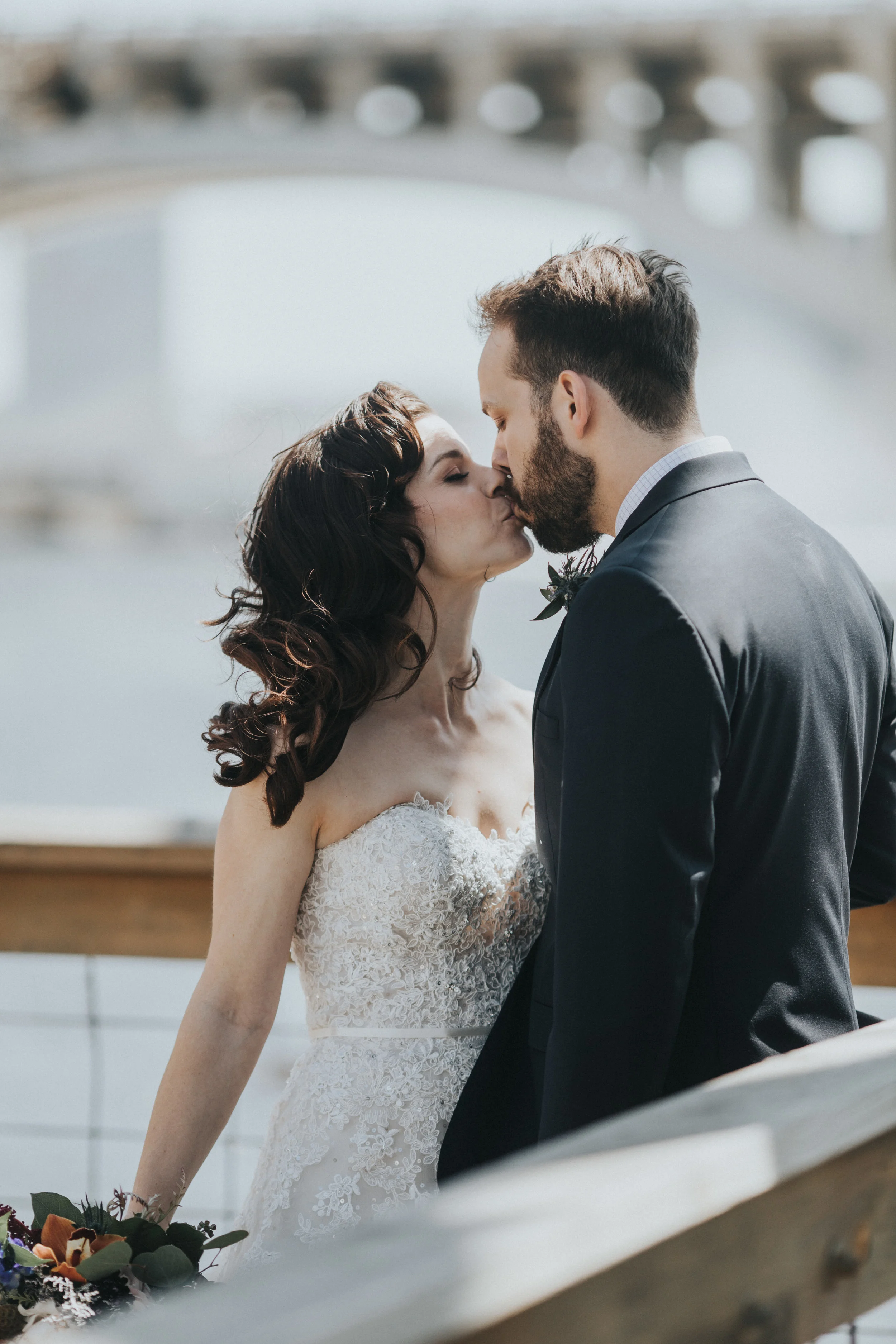 kiss on the deck at Nicollet Island | Russell Heeter Photography :: Minneapolis wedding planner Sixpence Events :: Nicollet Island Pavilion :: april wedding in Minnesota.jpg