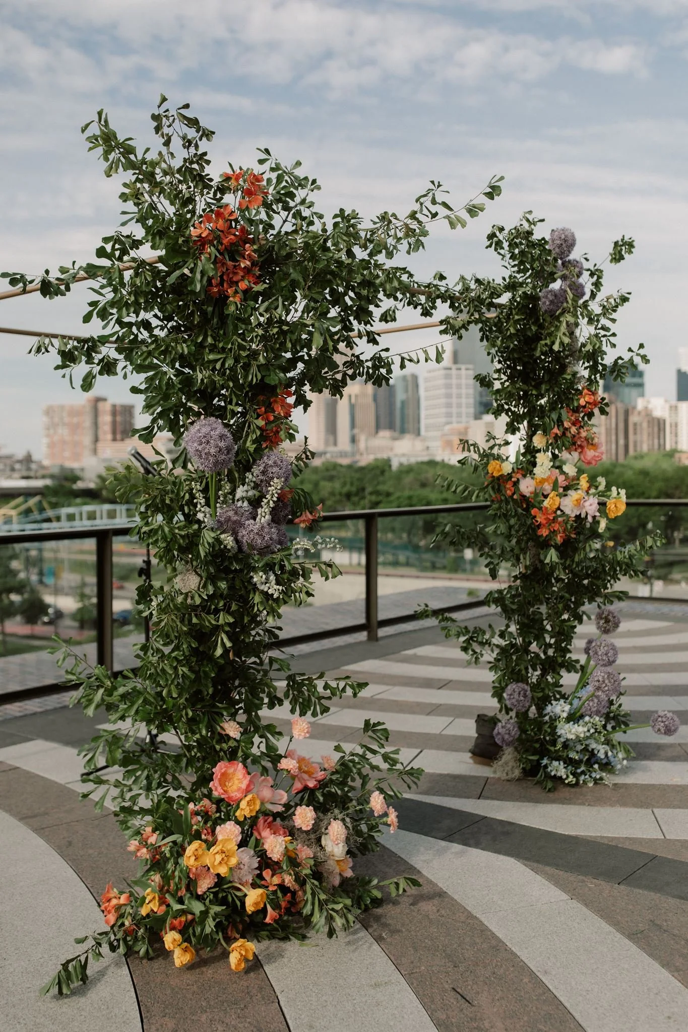 chuppah with the Minneapolis skyline in the backdrop and lots of greenery